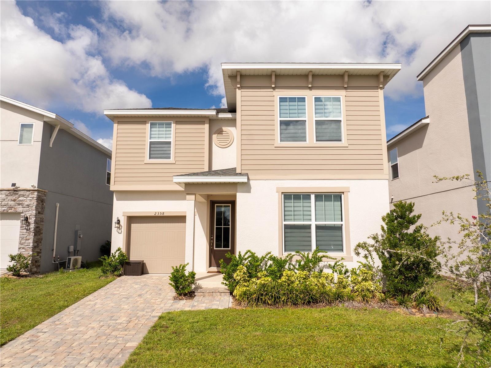 Welcome to this stylishly decorated home located at 2358 Salty Winds Way in the sought-after Solara Resort community of Kissimmee. This spacious residence offers six bedrooms and four and a half bathrooms, thoughtfully designed with both comfort and entertainment in mind. The open layout features a modern kitchen with granite countertops, stainless steel appliances, and a pantry, flowing seamlessly into the gathering room and breakfast nook. The first-floor owner’s suite provides a private retreat with a double vanity and large walk-in closet. Upstairs, a versatile loft, a private cinema, and a game room create additional space for fun and relaxation. The home also showcases beautifully themed childrens bedroom with Disney-inspired décor, alongside elegant and stylish design throughout. Outdoors, a covered lanai and private pool offer the perfect setting for entertaining or unwinding. Located in the gated Solara Resort, residents and guests enjoy access to resort-style amenities including a clubhouse, fitness center, and recreational facilities, all just minutes from Disney and Orlando’s top attractions.