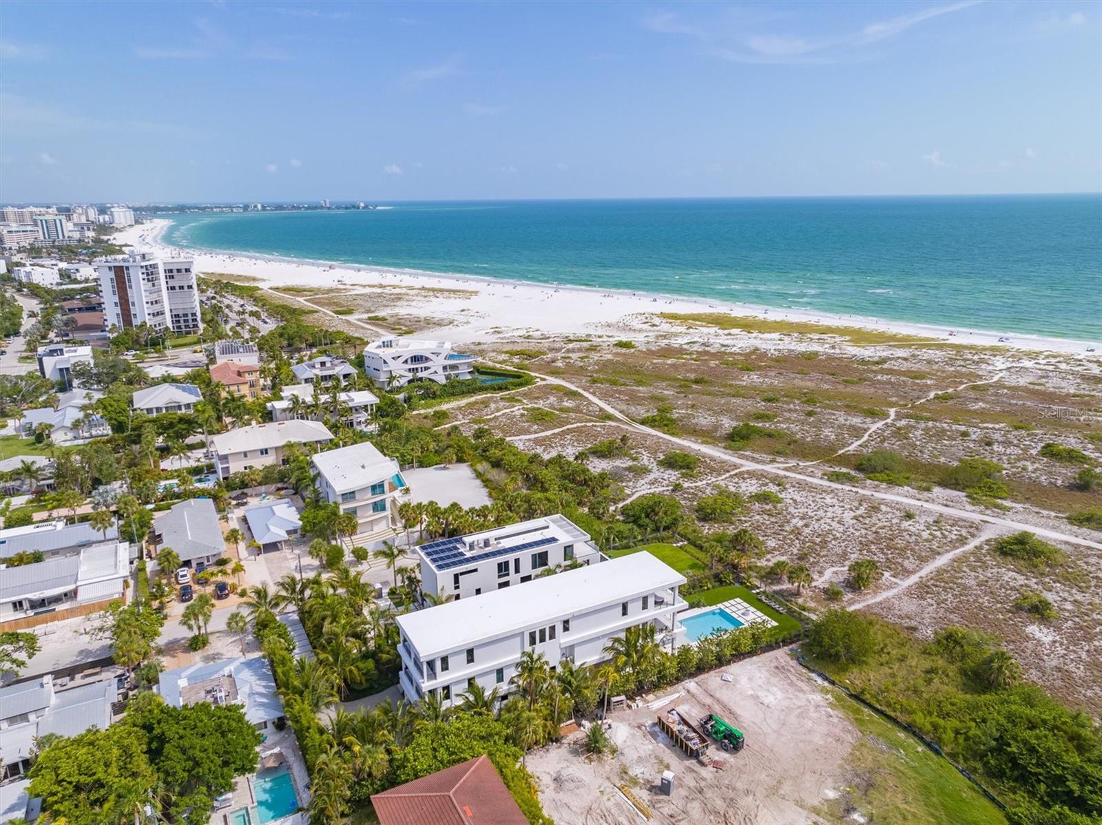 Gulf Front Luxury Living is at its Absolute Best in this Exquisite Estate in the Heart of Lido Key! It will be love at first sight when you enter this stunning newly-constructed 5 Bedroom, 5.5 Bathroom Gulf Front Estate. This home has it all including endless views of The Gulf of Mexico. With over 5,700 square feet under air, this home features Control I4 smart home automation, expansive living spaces with custom, designer finishes, 34 in-ceiling speakers, custom built-ins and motorized Lutron blinds throughout. First, enter through the Grand Foyer where you will be mesmerized by the breathtaking views of the sparkling waters of the Gulf of Mexico. Next, take the master staircase or commercial-grade elevator to the open-concept, main living area which features an oversized, luxurious living room with views of the crystal blue waters of the Gulf as you look out through the floor-to-ceiling, pocket sliding doors containing the highest quality windows. The main living level also features a gorgeous Gulf front dining room, detailed gourmet chef's kitchen featuring Sub Zero and Wolf appliances, separate walk-in pantry, conversation full bar sitting area with a walk-in, temperature-controlled wine room and a custom outdoor kitchen on the lanai. Then, continue up the grand staircase to your private hideaway master suite which includes an oversized bedroom, sitting and lounge area, balcony, walk-in designer closet, large designer bath area with spectacular finishes and, of course, more amazing Gulf views! This floor also features two additional guest suites with a separate den/lounge area for those suites. Back on the ground level, the expansive Gulf-front swimming pool and enormous surrounding deck offers significant, additional entertaining space. The huge pool has a central, negative-edge spa. The pool deck also features a lounging/dining areas, another custom outdoor kitchen and large activity area covered in all-weather, no maintenance professional turf. Professional landscaping placed with privacy in mind, a 6-car garage and a paved driveway with plenty of room for both owner and guest vehicles. All of this and you are a short stroll from the shops and restaurants of St. Armands Circle. Call me today to make your dream of owning an exquisite, luxurious Gulf-front Estate a reality!