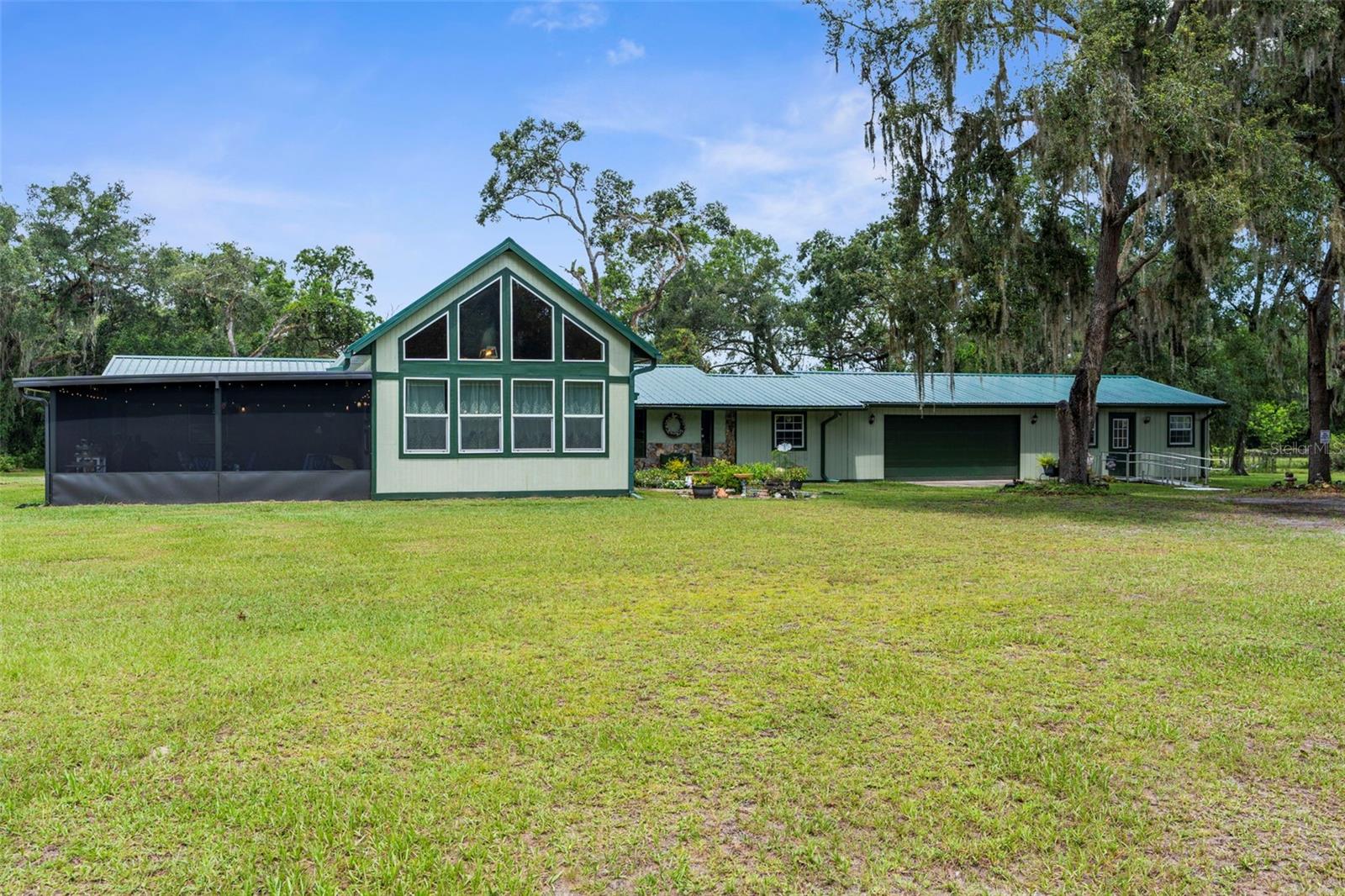 Exceptional Kennel Property on 15-Acres just minutes from I-75-this turn-key kennel property is located in the Hub of Florida’s thriving dog show scene. Nestled beneath a canopy of mature live oaks, this one-of-a-kind 15-acre property offers a rare blend of comfort, functionality, and natural beauty—ideal for animal lovers, breeders, or those seeking a private rural retreat. NO FLOOD ZONE
Main Residence Highlights:
* 3 Bedrooms-2 Bathrooms-2 car garage and over 3200 sf
* New Metal Roof Installed 2023; New HVAC 2025
* Spacious family room with dramatic 17' vaulted knotty pine ceiling
* Dream kitchen with loads of cabinets and Samsung appliances 2022
* Remodeled bathrooms with copper look ceilings
* Huge recreation/game room for entertainment and relaxation
* Indoor laundry room for added convenience
* Whole-house generator with 500-gallon propane tank
Outdoor Living & Infrastructure:
* Brand new 16x26 covered lanai—perfect for outdoor gatherings
* 2-car attached garage
* 7-car open garage with electric and attached workshop/equipment room
* 12x20 storage building with electric and A/C
* 20x24 covered pavilion ideal for events or leisure
* 24x24 pole barn with electric and (4) 12x12 stalls
* 50x50 fenced training/agility area
* 2 deep wells for reliable water supply
* Abundant wildlife including deer, sandhill cranes, and owls
Professional Breeding & Kennel Facilities:
* Multiple secure kennels
* Grooming shop with utilities
* 8x16 air-conditioned Kitty Shelter
* 12x50 fully A/C’d whelping/nursery room with indoor/outdoor runs leading to a 15x50 fenced area
* 20x40 fully fenced, covered kennel area
* Zoned for up to 15 breeding female dogs
This property is thoughtfully designed to accommodate a working breeding operation or a spacious, serene homestead. With extensive amenities, beautiful surroundings, and a peaceful, natural setting. Conveniently located approximately 40 minutes south of Ocala, 40 minutes north of Tampa and only 50 minutes to Orlando. Property can be sold with or without the kennel equipment.