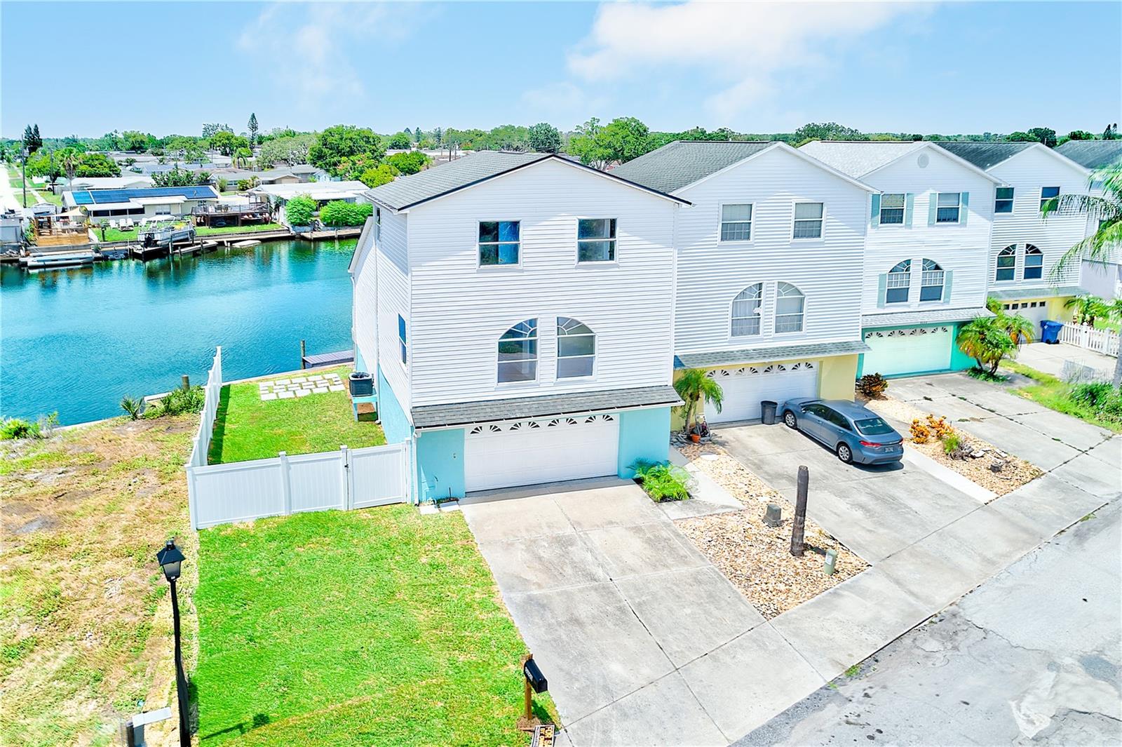 TRUE FLORIDA LIVING AT ITS BEST! Welcome to your waterfront oasis at 5253 Boardwalk Street in Holiday, Florida—where luxury meets lifestyle with direct Gulf access right from your backyard. This stunning 3-bedroom, 2.5-bathroom home has been completely rebuilt and reimagined with high-end finishes and thoughtful design throughout. From the moment you enter, you'll notice the open layout, filled with natural light from three large sliding glass doors that open to a spacious deck overlooking the water, private dock, and boat lift—perfect for soaking in sunsets or setting off on a day out to the Gulf.
The heart of the home is a brand-new kitchen featuring shaker cabinets, quartz countertops, all-new stainless steel appliances, and a hidden microwave built seamlessly into a custom pantry cabinet. New flooring runs throughout the entire home, tying together a modern color palette and a warm, inviting feel. Every bathroom has been fully redone with high-end tile floors and walls, new vanities with quartz tops, and stylish lighting. The primary suite offers a massive walk-in shower with dual shower heads, built-in bench, and niche, plus a dual-sink vanity and a private water closet.
What truly sets this home apart is the fact that it’s not just updated—it’s nearly new construction. After sustaining fire damage, the entire left side of the home was rebuilt with brand-new trusses, a new roof, new siding, and all-new systems including plumbing, HVAC, electrical, and insulation. Inside, you’ll also find a dedicated indoor laundry room and a two-car garage with additional under-house storage—features not commonly found in many nearby homes.
Unlike many homes on this street, this property includes a fully fenced yard with vinyl fencing on the left side—ideal for pets, or outdoor entertaining. Whether you’re a boater, a sunset lover, or simply looking for a home that offers both peace and tranquility, this is your chance to own a true move-in ready retreat with all the hard work already done. Come experience coastal living at its finest on Boardwalk Street.