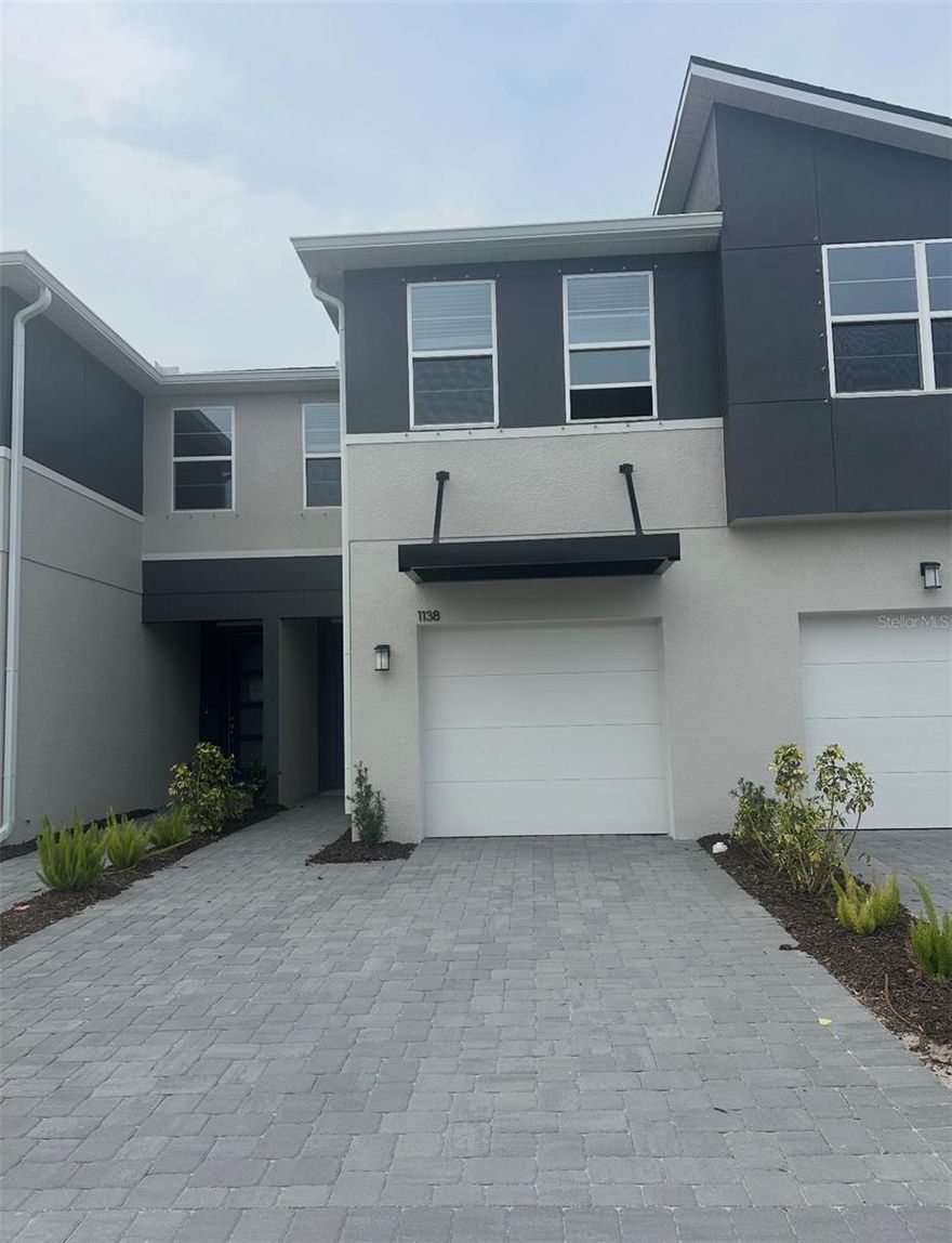 This 1,667 square foot home features 3 bedrooms, 2.5 baths, loft, and 1 car garage with a 2-car wide paver driveway.  The Marianna features a Modern elevation and backs up to a privacy fence for extra seclusion. The huge eat-in kitchen is truly the heart of this home. Featuring quartz counter tops  that are a great contrast against the abundance of  42" Stone Gray painted cabinets and 17 x 17  tile flooring that flows from the front door through to the lanai. You also will not be disappointed with this home's appointments, including cabinet hardware and stainless appliances (including the fridge & Washer/Dryer). The large center island layout makes this home ideal for entertaining as it overlooks both your great room and the very spacious, covered, screened and brick paver lanai. Upstairs, the owners retreat, separate from the guest rooms, offers a large walk-in closet, a double sink vanity and an oversized shower. Just off the owners suite is a large loft, that's perfect for entertaining or relaxing after a long day. The secondary bedrooms feature walk-in closets and share a large bathroom and separate linen closet adjacent to the loft. This home does not disappoint, with its extra storage and fabulous outdoor living space. Bloomingdale Townes is a gated community with a large pool and BBQ area.