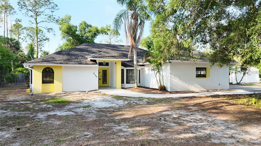 *TAKE A WALK THROUGH YOUR NEW HOME WITH THE 3D INTERACTIVE TOUR* Looking for country living just minutes from all that Florida has to offer? Welcome to this private and serene 3-ACRE estate in North Port, featuring 3 bedrooms, 2 bathrooms, a 2-car garage, and an open-concept floor plan with your own private POOL. Recent updates include a 2022 water heater, NEW electrical panel, and pool resurfacing (2026) for added peace of mind. As you enter, a spacious foyer invites you into the home, where wider doorways and thoughtful design enhance flow and functionality throughout. The living and dining area features soaring ceilings, neutral tones, and abundant natural light through triple cascading sliding glass doors. Tile flooring runs throughout the main living areas, offering both durability and easy maintenance. The kitchen is designed for both everyday living and entertaining, featuring abundant cabinetry, ample counter space, and a functional U-shaped layout. A skylight fills the space with natural light, while the breakfast bar opens seamlessly to the main living area.  A separate family room adds additional living space and showcases a floor-to-ceiling stone fireplace with a polished brass insert, creating a warm and inviting focal point. The primary suite is spacious and comfortable, offering a walk-in closet, private lanai access, and a flexible bonus area perfect for a desk or creative space. The en-suite bathroom features dual sinks, a linen closet, a Roman walk-in shower, and a relaxing garden tub. The split-bedroom floor plan provides privacy, with two guest bedrooms and a well-appointed bathroom on the opposite side of the home. The guest bath includes wood wainscoting detail, adding warmth and character. Multiple sliding glass doors lead to the expansive screened lanai—an ideal space to relax, entertain, or enjoy outdoor dining while surrounded by peaceful natural views. The private pool offers the perfect place to cool off, complete with an outdoor shower for added convenience. Set on 3 acres, the property provides a blank canvas for outdoor living, gardening, or future expansion. Mature trees and natural landscaping enhance the sense of privacy, while a gated entry and partial fencing add security and functionality. Located in North Port Estates, a non-deed restricted community on the north side of I-75 between the Myakka and Peace River and near Carlton Preserve, you’ll enjoy miles of scenic trails for walking, biking, hiking, and horseback riding. Conveniently close to I-75, US-41, shopping, dining, and golf. This is a must-see property offering space, privacy, and endless potential. Schedule your showing today.