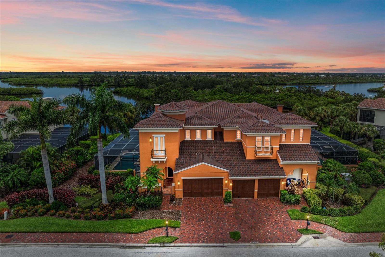 Florida luxury riverfront living in the gated community in Waterlefe Golf & River Club. This Mediterranean Coastal-style home is located on the Manatee River with spectacular panoramic water views. Being sold Turnkey furnished, it also includes a deeded boat slip located in the community marina with access to the Manatee River and The Gulf. This spacious two-story home offers 3,240 sq ft of living for a perfect blend of comfort, style, and functionality with 4 bedrooms, 4.5 baths, separated living and dining rooms, beautiful high coffered and tray ceilings, hurricane rated impact windows, remote controlled window shades, crown molding, central vacuum, in-wall pest system, built-in ceiling speakers, screened-in heated swimming pool and jacuzzi, outside kitchen and bar and a second-story screened-in balcony with amazing views of the River. This home has extensive upgrades throughout and shows like a model. Ideal for entertaining, the impressive kitchen is outfitted for a culinary enthusiast with stainless steel appliances including a gas stove with built-in vent, built-in wall oven, convection oven, wine fridge, travertine backsplash, granite counters, solid wood cabinets, breakfast bar, pantry and extra storage cabinetry. The kitchen is completely open to the living room for gatherings with family and friends, or to enjoy warming up next to the gas fireplace during the cooler months. The primary bedroom will take your breath away with the awe-inspiring water views and features direct access to the lanai overlooking the pool. The ensuite bathroom adds a touch of luxury with its thoughtful finishes, designed with a gorgeous soaking tub to take all your worries away, large walk-in shower with dual shower heads and dual custom-built walk-in closets. The large dining room provides plenty of space for dinner parties for your friends and family. The laundry room offers a front-load washer and dryer, utility sink and an abundance of extra storage cabinets. Upstairs, the additional 3 bedrooms all have ensuite bathrooms and custom built closets, and allows access to the screened balcony to enjoy stunning water views and beautiful sunsets. Walk through the glass doors to the outdoor screened paved area to enjoy the swimming pool, jacuzzi, outdoor kitchen with bar and grill for fun and entertainment. Within the screened pool area, you will find a covered patio with plenty of space to soak in the sun or to BBQ your favorite meal. You can also enjoy the serenity of a view to catch a glimpse of a variety of wildlife, beautiful birds and spectacular sunsets. Waterlefe Golf & River Club offers an active lifestyle with countless activities. Waterlefe River Club serves as the community hub, featuring a delightful restaurant, bar, fitness center, meeting rooms, and a resort-style swimming pool with a tiki bar alongside the many comfortable lounge chairs. Get to know your neighbors at a variety of social events from fitness classes to card games, book clubs to social events. You will find nature trails for walking and biking, boating, kayaking and fishing. Optional golf club memberships at an award-winning, semi-private, championship golf course. The Association fee includes cable, internet, exterior maintenance including roof replacement (replaced in 2024), water, sewer, trash, painting and yard maintenance. Wake up each day knowing you are living your dream in this true Florida waterfront paradise.