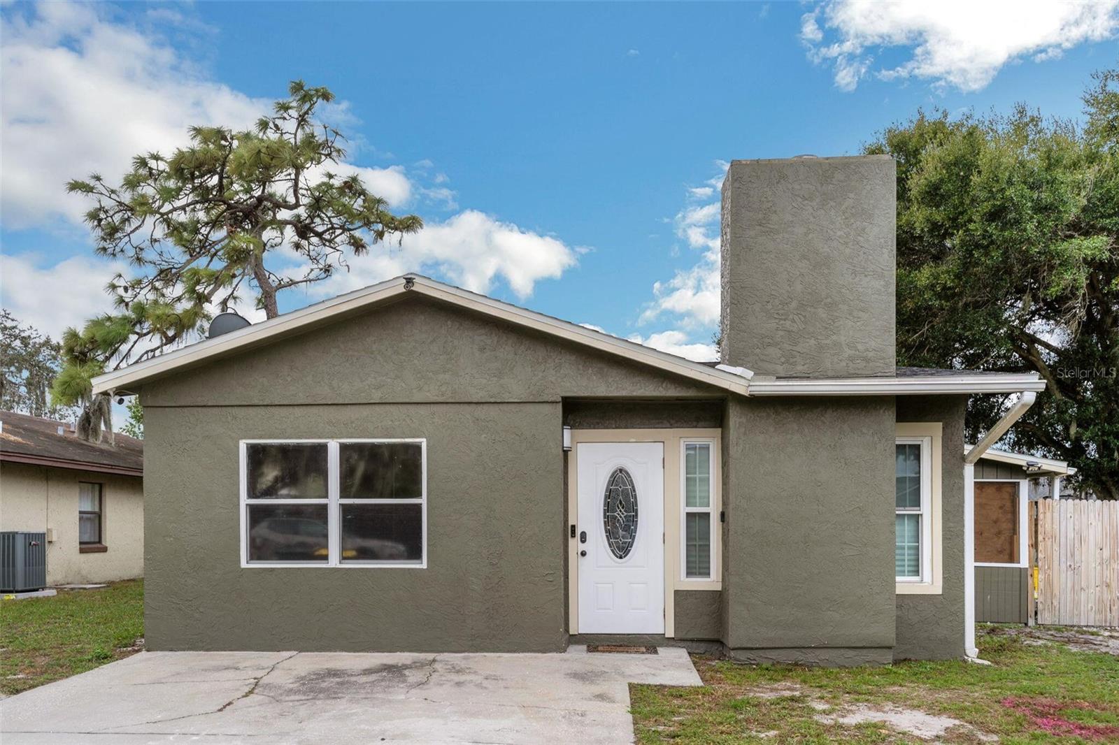 Welcome to a charming residence that has a very livable floor plan with open concept and split bedrooms. The interior architectural interest and visual appeal complement this 4 BD/2 BA home that has a neutral palette and vaulted ceilings that enhance the sense of openness. Nestled in a quiet, well-established neighborhood, the home is finished with vinyl floors, ceiling fans and granite counter tops. The main focal point of the living room is the fireplace, while French doors open expanding the living area to a screened lanai. A dining area stands near the cheerful kitchen that’s outfitted with plenty of cabinetry, granite countertops, a bar on both sides and stainless-steel appliances. Retreat to the master bedroom with en suite bath. The split bedroom plan has the additional bedrooms sharing a full bath with single sink vanity. Lounge, relax or entertain guests in the screened lanai, the cowboy pool with a dome covering it and a deck. There is also an 18-hole mini golf which can be left or taken out in the backyard that is fenced in. Definitely make plans to see this attractive home and enjoy its peaceful location and easy access to SR-Hwy 60 and other main thoroughfares for all daily necessities. Roof 2018, Water Heater 2022, AC 2017