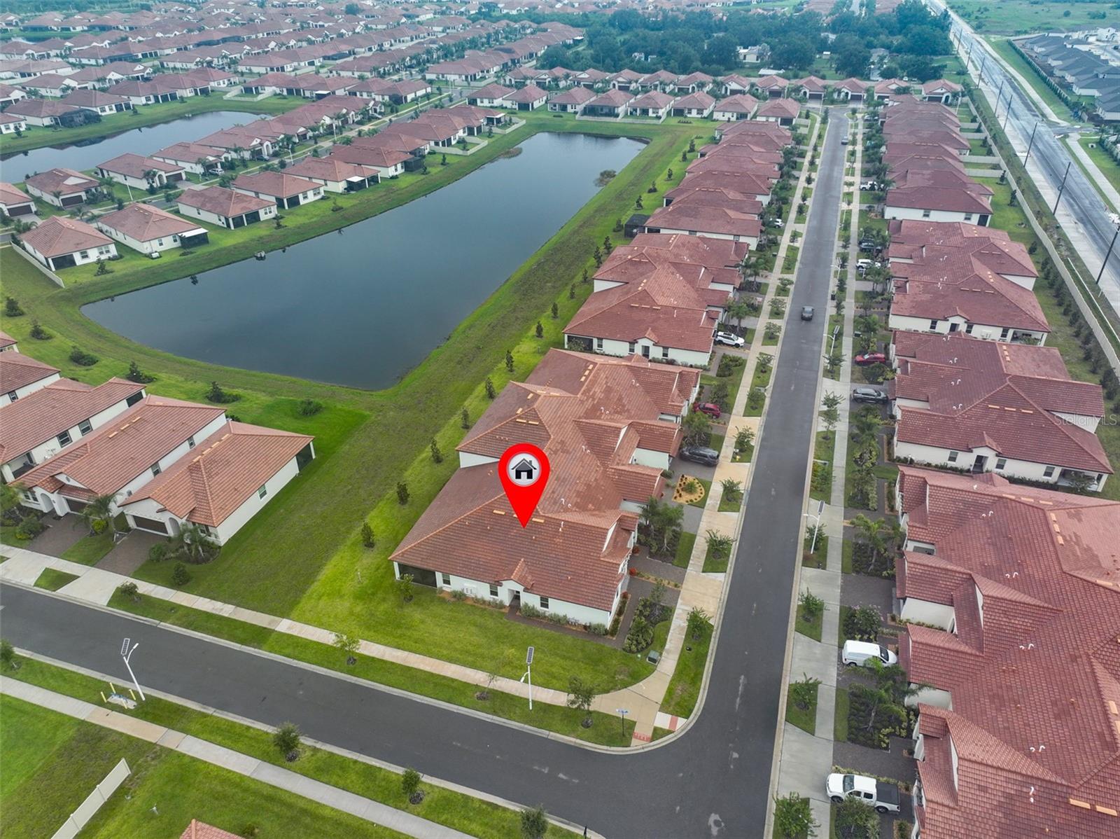 Step into the realm of refined living and discover the allure of this sophisticated villa! The gorgeous 55+ luxurious community of Medley, within the amenity rich Southshore Bay community OFFERS IT ALL! This stunning corner-lot villa offers you a 'BETTER THAN NEW' home with MINIMAL USE, a NO PET, NON-SMOKING home with UPGRADES, this home is sure to fit like a glove! Some highlights include PAVER DRIVEWAY, MOUNTED OVERHEAD GARAGE STORAGE, SMART HOME TECHNOLOGY, ULTRA EFFICIENT GAS TANKLESS WATER HEATER, LIGHTIING FIXTURES, GAS RANGE for the home cook, GAS DRYER, CROWN MOLDIING, TIMBERLAKE CABINETRY, QUARTZ COUNTERTOPS, ROCK LANDSCAPING and mulch, CHAIR RAIL IN HALLWAY, AND SCREENED IN LANAI! Upon entering your new home, you will appreciate all the light the windows bring in from being a CORNER UNIT instead of a middle unit! For all you gourmet cooks, you will love the OVERSIZED KITCHEN with a WALK-IN PANTRY, GAS RANGE for precision cooking, LARGE BREAKFAST BAR, LOTS OF STORAGE, and ROLL OUT CABINETS! You will not miss out on any home entertaining as the STANDOUT KITCHEN is in range of entertaining your guests! Your expansive primary suite is well-equipped with a HUGE 11ft. WALK-IN CLOSET that is situated outside of your bathroom. The linen closet is just outside the door of the bathroom as well! Double sinks and a SPACIOUS AIR CONDITIONED WATER CLOSET make this suite a delight! The guest bedroom and bath are at the other end of the home, creating a sense of privacy and tranquility. Enjoy the flex room as an office, hobby room or library. In the evening, escape to your quaint lanai for beverages and grilling with a peek-a-boo view of the large pond. The HOA includes access to a private 55+ Clubhouse at the Medley with a resort style pool, fitness area, and food/beverage service, roof coverage, exterior maintenance, lawn maintenance, cable, internet, irrigation water, and 24-hour guard gated service for added peace of mind. Entertaining guests? Take them to your MULTI-MILLION DOLLAR Southshore Bay LAGOON where you can relax ON THE BEACH, GO DOWN THE WATER SLIDE, USE THE OBSTACLE COURSE, KAYAKS AND PADDLE BOARDS AND ENJOY THE CONCERTS! Live your best life right from home, ALL DAY, EVERY DAY!