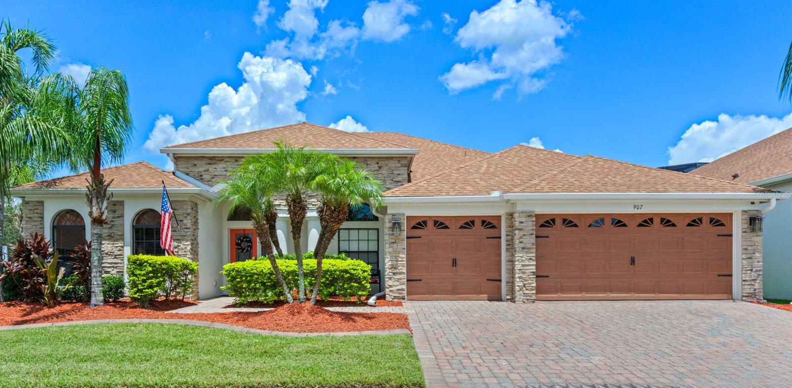 Welcome to Your Dream Home in a Tree-Lined Neighborhood!
This meticulously maintained one-story, 4-bedroom, 3-bath home offers 2,756 square feet of thoughtfully designed living space on a desirable corner lot. From the paver driveway and real stone exterior accents to the custom holiday lighting and manicured landscaping, curb appeal abounds.
Inside, the layout is the perfect blend of open-concept and privacy. A formal dining room with hardwood floors and elegant wainscoting sits across from a versatile theater room (formerly the formal living room), already wired for sound. The gourmet kitchen features white cabinetry, granite counters, stainless steel appliances (all under 4 years old), an island with electric outlet and additional storage, and a custom walk-in pantry. Enjoy morning coffee in the cozy eat-in nook or entertain at the extended counter bar.
The family room opens fully to the lanai and screened saltwater pool area, offering a seamless indoor-outdoor flow. Custom remote-controlled shades, recessed lighting, and luxury vinyl flooring bring both style and convenience.
The private primary suite features sliding door lanai access, dual custom built walk-in closets, and a spacious sitting area. The primary spa-like bath has a garden tub, walk-in shower, and dual vanities. Three additional bedrooms and two full baths—including a convenient pool bath—offer flexibility for guests, work-from-home, or family needs.
Outdoors, the screened lanai and three-year-old saltwater pool with travertine tile, sun shelf, fire bowls, water features, privacy panels, and raised spa create an unforgettable oasis. The fenced backyard offers partial lake views and added privacy with a remote-controlled screen and privacy panels.
Recent Upgrades & Features Include:
• Brand-new AC (June 2025) w/ 12-year warranty
• Newer roof, fresh exterior paint, full gutters
• Three-car garage with built-in cabinets & attic storage
• Pre-wired security system with outdoor cameras
• Crown molding, custom window treatments, remote shades
• Water softener, luxury vinyl tile, recessed lighting & dimmers
Prime Location
Located in a friendly, long-established community near top-rated schools (all within 3 miles), a neighborhood park, and just minutes to Waterford Lakes, UCF, Valencia College, shops, dining, and major commuter routes.