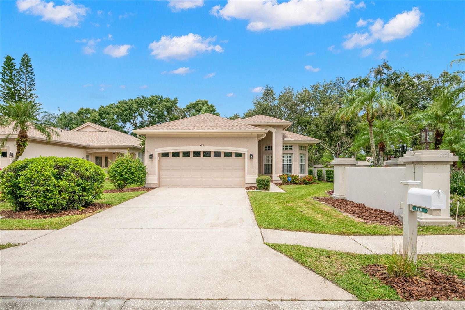 Walk up as you take in the lush landscape and brick paved front porch; Step inside this lovely home in the highly sought-after East Lake Woodlands neighborhood of Cross Creek and be immediately impressed by its open and inviting layout. Interior highlights include light & bright kitchen with white raised-panel cabinetry, double stainless-steel sink, large pantry with built-in shelving, and cozy breakfast nook with abundant natural light. The breakfast bar is open to the dining and living areas, creating the perfect space for entertaining, while the spacious living room with pocket sliding doors leads to your screened-in porch, where you can access your private side yard. The primary suite is located off the rear of the home and boasts two walk-in closets and an en suite bath featuring jacuzzi soaking tub, step-in shower, dual-sink vanity with built-in makeup area, and private water closet. The bonus room has a double-door entry and would be ideal as a third bedroom, home office, or den. The second full bath has a tub/shower combo and large vanity with storage. The generous second bedroom has a large wall closet and lovely natural light. Laminate wood flooring throughout the main living spaces and tile in kitchen/entry/laundry makes for easy maintenance. The laundry room has upper cabinets, deep tub sink with cabinetry below for extra storage. From here you access your oversized 2-car garage. Located a short distance to the Cross Creek community pool, you will love all that this location has to offer. There are optional membership opportunities at East Lake Woodlands Country Club with golf, tennis, fitness, and more. This ideal location is near shops, dining, and Gulf beaches. This home offers the perfect blend of open living spaces, abundant storage, and resort-style amenities, all within a peaceful gated community. You will love how well cared for this home is ...—schedule your showing today and start enjoying the Florida lifestyle!
