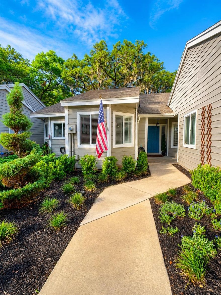 Welcome home to this charming 2-bedroom, 2-bath villa located in the heart of Jonesville area. Nestled beneath mature oak trees in The Villas of West End, this beautifully maintained home offers peaceful views of walking trails at the West End Community park while being just minutes from Tioga Town Center, Publix, restaurants, fitness studios, and I-75. Tucked away on a quiet cul-de-sac, the setting feels private and serene while still close to everything Gainesville has to offer. Inside, vaulted ceilings and natural light create an open, airy feel. The kitchen features granite countertops, stainless appliances, and custom pendant lights imported from the French Riviera, adding a unique touch to the heart of the home. Thoughtfully designed with warm California-inspired style and subtle European influences, the spaces feel both elevated and comfortable. The Florida Sunroom and patio extend the living space outdoors, overlooking peaceful greenery- perfect for morning coffee or relaxed evenings at home. Newly installed oversized Coastal Mist tile adds fresh feel inspired by the tones of the California shoreline, while fresh landscaping enhances the home's curb appeal and welcoming atmosphere. Additional updates include a 2018 roof and new water heater, offering peace of mind for future owners. Residents enjoy access to community amenities including a pool, clubhouse, and tennis courts. Move-in ready and full of charm, this home offers an easy, low-maintenance lifestyle in one of the area's most desirable locations. Contact listing agent today to schedule your private showing and experience the peaceful lifestyle this hidden gem has to offer. This information is deemed reliable but is not guaranteed.