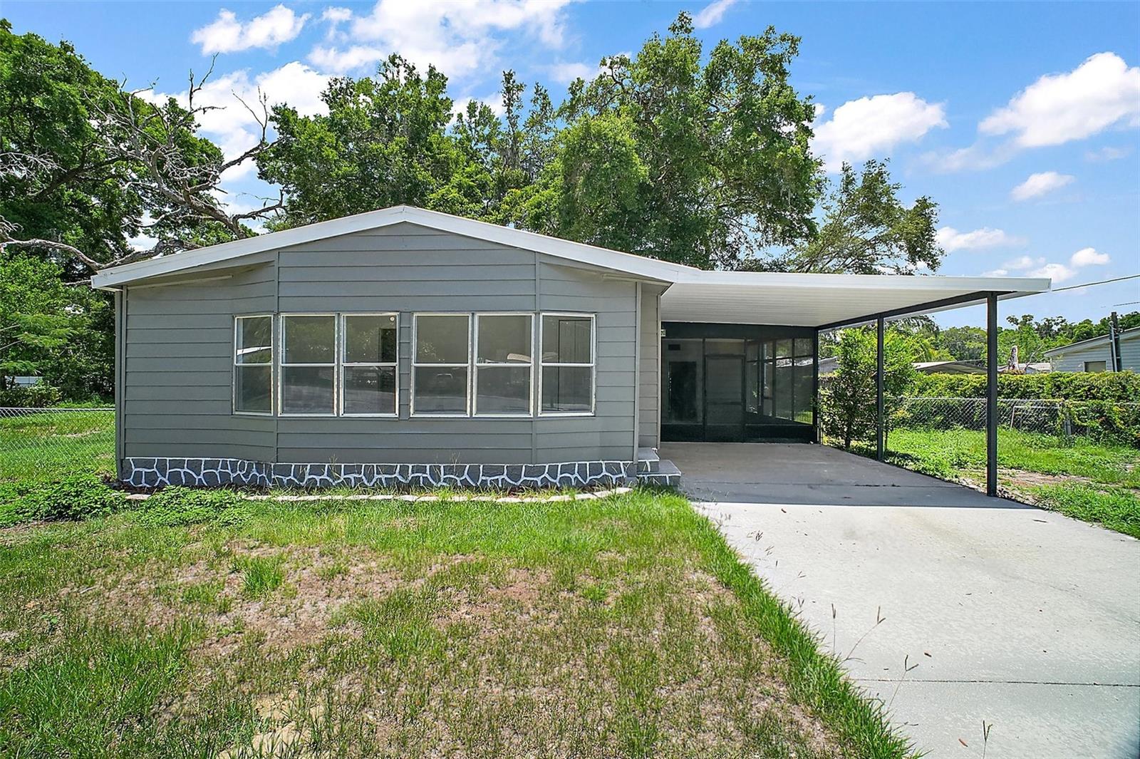 One or more photo(s) has been virtually staged. Move-in Ready & Tucked Away! This inviting 3-bed, 2-bath home sits at the end of a quiet cul-de-sac in Belleview, offering an open-concept layout with luxury vinyl plank flooring, a bright modern kitchen featuring all-wood cabinets, stone countertops, and brand-new appliances. Stylish, comfortable, and ready to enjoy—no updates needed. A durable metal roof, new A/C, and no flood zone add lasting peace of mind. Outside, the lush fenced yard includes an attached carport, a personal workshop, and a storage shed— for projects, parking, or weekend hobbies. Just minutes to Lake Weir, Carney Island, shopping, dining, and quick access to Ocala and The Villages. An incredible place to settle in and make your own.