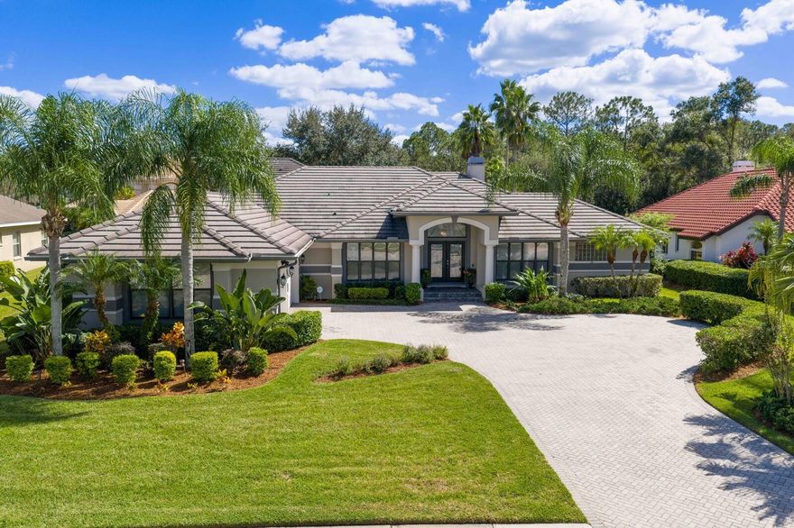 Located in the prestigious manned and guard-gated community of Cory Lake Isles, this one-of-a-kind custom estate sits on an oversized homesite with private conservation views. From the moment you arrive, the curb appeal is undeniable, an impressive winding pavered driveway leads to a charming courtyard entry and stately double-door foyer. Inside, you’ll find 5 bedrooms, 5 bathrooms, a private office, and a large bonus room, all showcasing custom craftsmanship and rich finishes.

The grand foyer sets the tone with soaring scale, column accents, and wood floors that flow through most of the home. The office features plantation shutters, built-ins, and elegant wood flooring, while the formal spaces impress with crown molding, a coffered ceiling, wet bar, built-in hutch, and a wood-burning dual fireplace that is featured in both living room and primary bedroom.

The primary suite is a true retreat with wood floors, and a spa-inspired bath featuring tumbled marble flooring, walk in closet, detailed tile accents, and custom maple cabinetry. The gourmet kitchen is designed for entertaining with stainless steel appliances, double ovens, maple cabinetry, granite countertops, and an oversized island workstation.

The split floor plan ensures privacy, placing the primary suite near the formal areas, two bedrooms near the kitchen and family room, and two more bedrooms toward the rear of the home. The family room highlights wood floors, custom built-ins, and pocket sliding glass doors opening to the outdoor living space. Upstairs, the oversized bonus room offers a full bath and kitchenette with refrigerator, sink, and microwave—perfect as a media room, guest quarters, or in-law suite.

The outdoor oasis is extraordinary, with a full outdoor kitchen, large covered lanai, heated spa, cascading waterfall, fire pit seating area, and extended pavered patio, all surrounded by lush landscaping.

Cory Lake Isles is more than a neighborhood, it’s a lifestyle. Residents enjoy a 165-acre ski lake for boating, fishing, and water sports, along with resort-style amenities including a waterfront beach club, fitness center, playgrounds, parks, tennis and pickleball courts, and a community pool. This rare estate offers luxury living inside and out, with the best of Tampa’s premier gated lakefront community. Welcome Home!