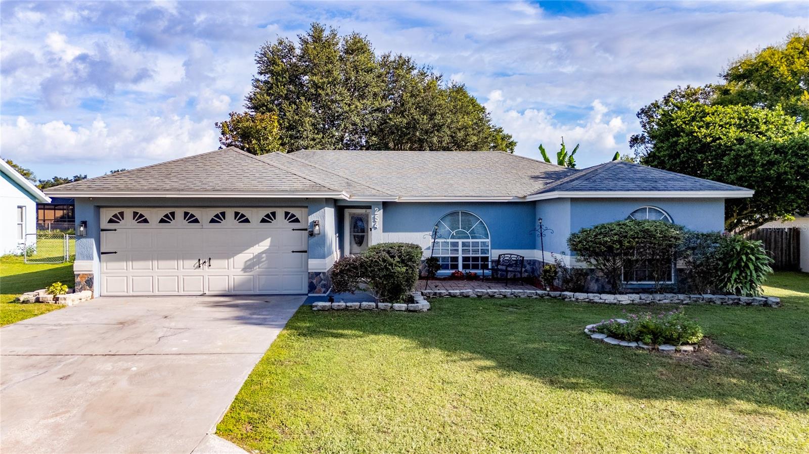 Welcome to this inviting Pool home where comfort meets family living. Featuring 3 bedrooms, 2 bathrooms, and spacious living areas, this home is designed for gathering, relaxing, and enjoying Florida’s lifestyle year-round. The entire home boasts beautiful laminate flooring (no carpet!). The interior and exterior have been freshly painted, giving the home a bright, clean, and move-in ready feel. As you enter, you’ll find a cozy living room to the right, perfect for quality time with family and friends. The home flows seamlessly into a dining area overlooking the pool, next to a kitchen with stainless steel appliances, including a digital refrigerator. The primary bedroom offers plenty of space along with a remodeled bathroom with elegant finishes. The other two bedrooms are versatile and comfortable, ideal for additional rooms, an office, or guest space. The second bathroom has also been updated, providing a fresh and contemporary style. From the kitchen, you step out to a spacious fully fenced backyard featuring a covered patio, screened-in pool enclosure, and a convenient outdoor shower. The backyard also offers a tropical atmosphere with fruit trees such as papaya, lemon, guava, and mango, plus two sheds providing extra storage space. Located in an area with excellent schools and with easy access to I-4 towards Orlando and Tampa, this home combines warmth, comfort, and convenience. Schedule your appointment today!