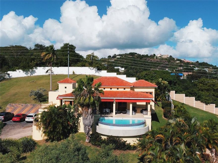 Elegant Mediterranean 2-Story 4200 sq ft Estate nestled in the  Palmas Del Mar Beach and Golf Resort. This award winning master planned gated community on the southeast coast of Puerto Rico is a short 35 mile drive to San Juan. The high ceilings combined with the breathtaking ocean views and breeze affords this 4 Bedroom, 2 full bathrooms, 2 half baths , home a year-round relaxed cool feel. A very spacious gourmet kitchen and open-concept living space provides an ideal setting for family gatherings and entertaining. Couple that with a tantalizing, airy and bright interior garden and you have the perfect mix of style and nature. The infinity pool , private terraces, and grand one acre garden area a privileged way to savour the spectacular sunrise over an infinite ocean. 

Convienient location, outstanding schools, beaches , tennis, and golf course are some of the ammenities that make this property and ideal place to call home.