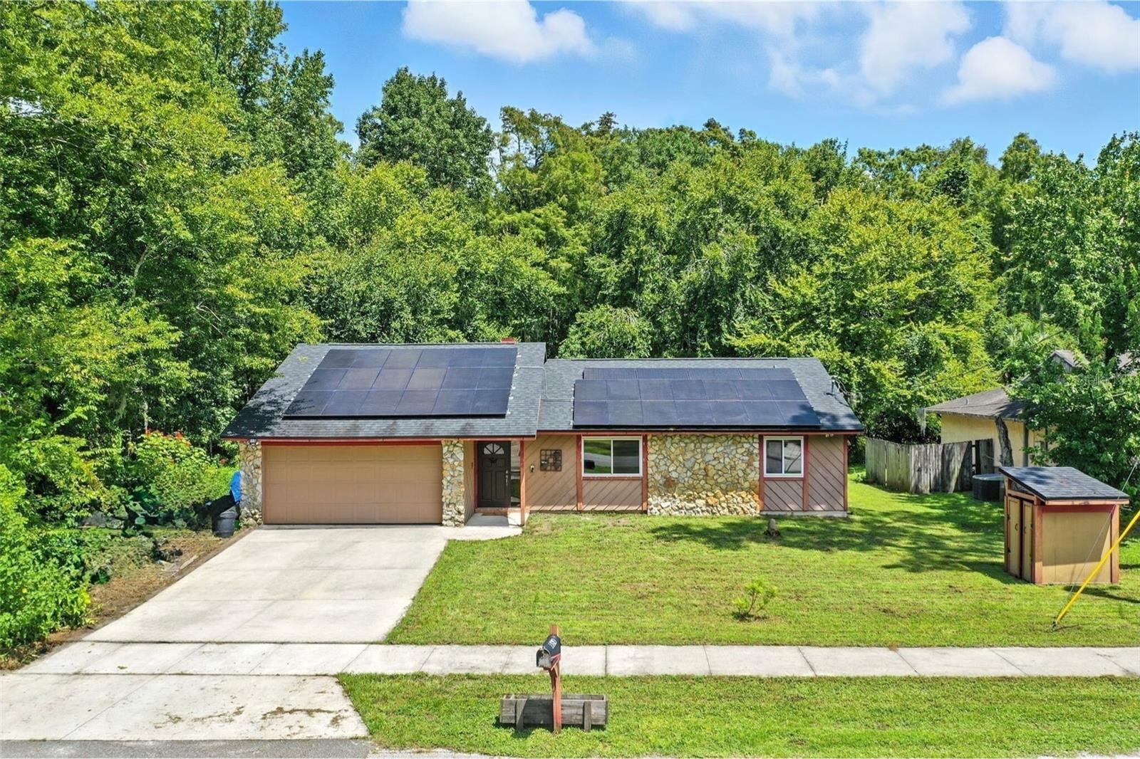 Welcome to this charming 3-bedroom, 2-bath home tucked away at the end of a quiet dead-end street in Longwood. Surrounded by a treed conservation area with no backyard or side neighbors, this retreat offers rare privacy while staying close to Lake Mary Blvd shopping, the YMCA, and top-rated Seminole County schools. Inside, the open floor plan with vaulted ceilings makes the 1,400 sq. ft. layout feel spacious and inviting. A stone fireplace anchors the Great Room, while the updated kitchen features granite counters, stainless appliances, and crisp white cabinetry. The split bedroom design includes a private primary suite with double vanities and two additional bedrooms. Enjoy mornings on the brick-paved screened patio overlooking lush greenery. Recent upgrades include a new roof (2020) and all new windows installed in 2025. Complete with a 2-car garage and eco-friendly solar panels, this home blends modern comfort with peaceful living. Don’t miss this Longwood gem!