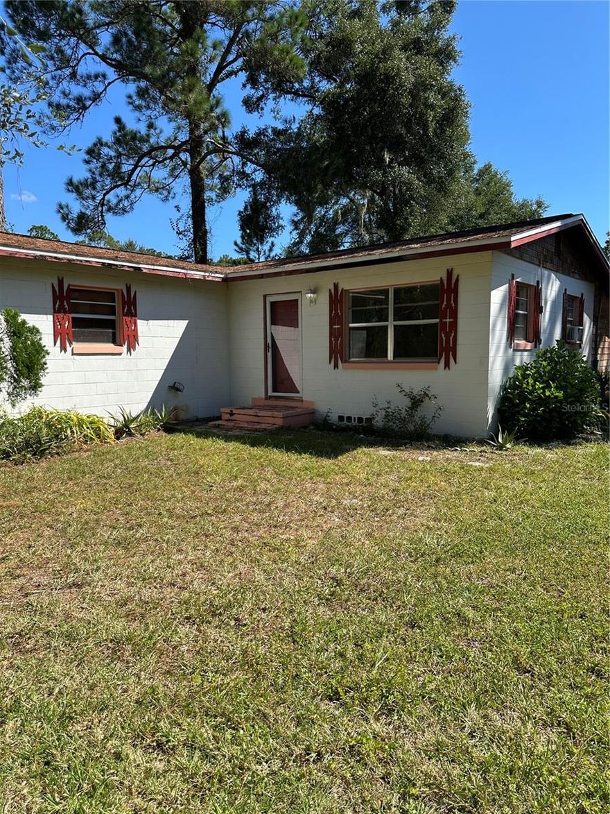 HUNTING, FISHING, QUIET AND PEACEFUL FLORIDA  SURROUNDINGS FOR YOUR NEW  HOME.  ALMOST 1/2 ACRE IN FORT MCCOY! ON A PAVED ROAD!!  Block home with a wonderful workshop, shed and fenced yard.  Great Potential!  2-bedroom, 1-bath home in a country-like setting.  Hardwood flooring and HISTORIC charm. The kitchen leads directly to a convenient laundry area. A Large bonus room with ceramic tile offers additional living space that can really be almost anything.  This property includes a well and septic system. Additional features include a large storage closet, a detached shed, and a workshop—ideal for all your toys and equipment. Bring your vision and transform this home into your idea retreat!  Whether you are looking for a Retirement Retreat, Hunting Camp or just some great Rural Living, this is potentially Your New Home!
