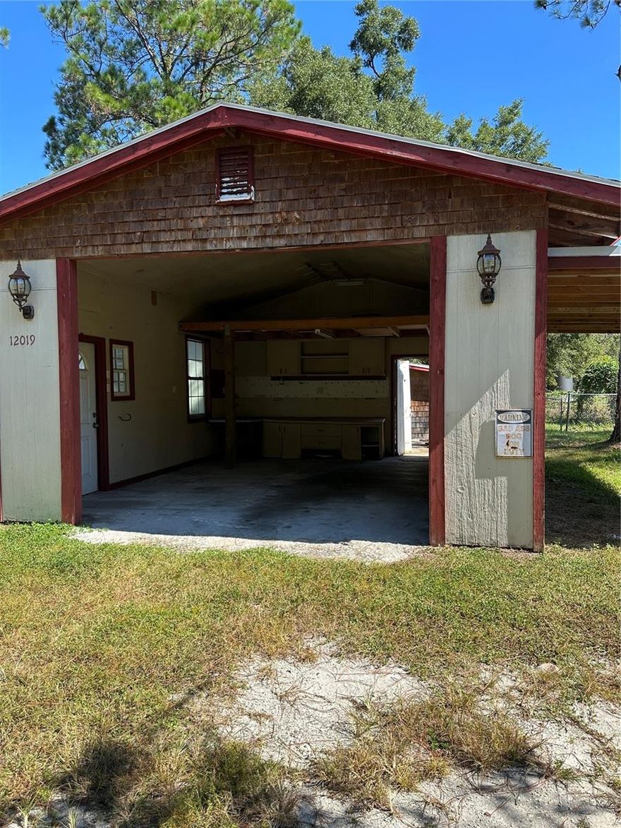 HUNTING, FISHING, QUIET AND PEACEFUL FLORIDA  SURROUNDINGS FOR YOUR NEW  HOME.  ALMOST 1/2 ACRE IN FORT MCCOY! ON A PAVED ROAD!!  Block home with a wonderful workshop, shed and fenced yard.  Great Potential!  2-bedroom, 1-bath home in a country-like setting.  Hardwood flooring and HISTORIC charm. The kitchen leads directly to a convenient laundry area. A Large bonus room with ceramic tile offers additional living space that can really be almost anything.  This property includes a well and septic system. Additional features include a large storage closet, a detached shed, and a workshop—ideal for all your toys and equipment. Bring your vision and transform this home into your idea retreat!  Whether you are looking for a Retirement Retreat, Hunting Camp or just some great Rural Living, this is potentially Your New Home!
