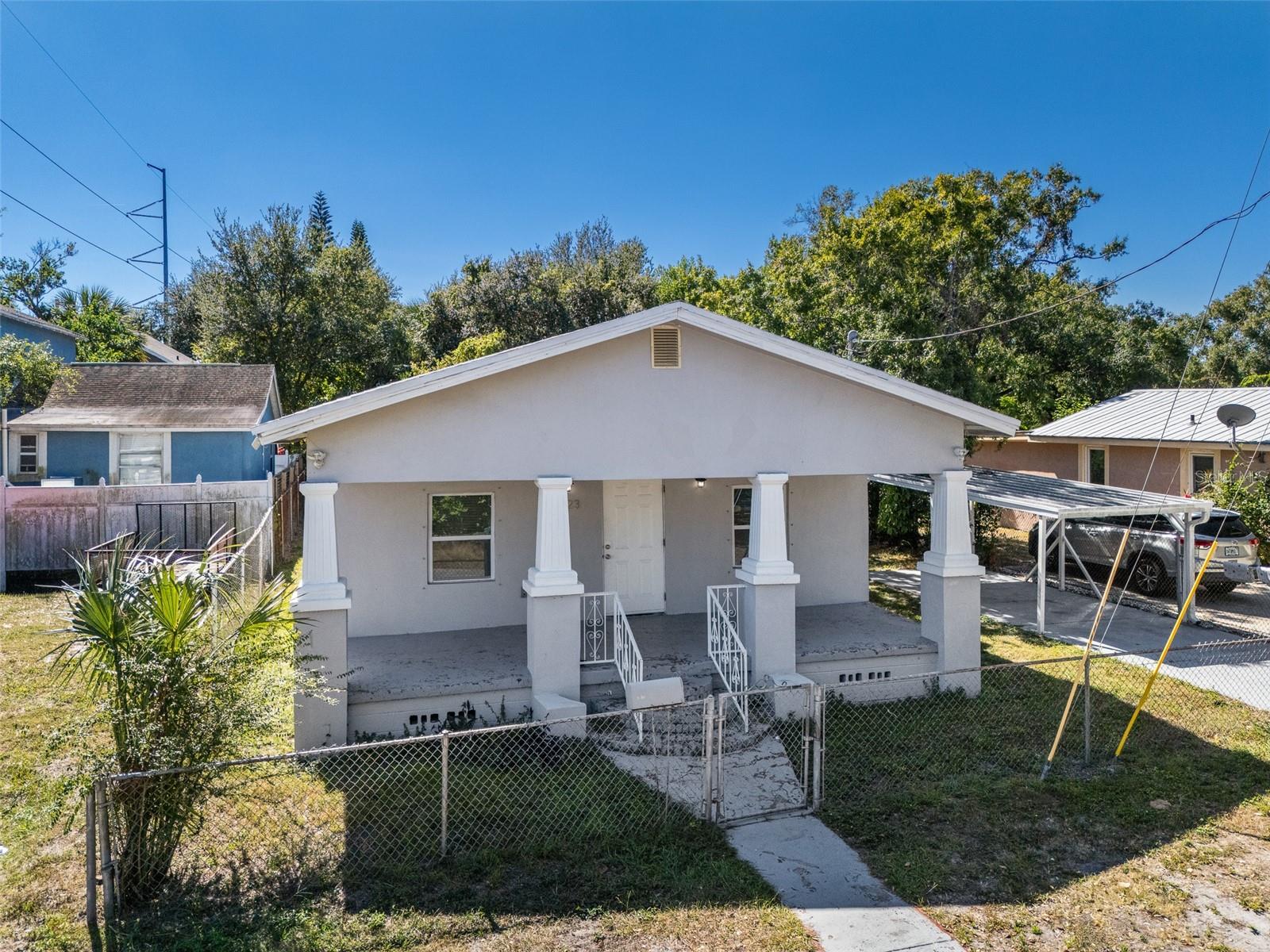 Experience the complete revitalization of this stunning 3-bedroom, 1-bathroom single-family home in a fantastic East Tampa location. Absolutely everything is brand new as of 2024, including the HVAC system, AC ductwork, roof, electrical, windows, and doors, ensuring peace of mind and worry-free living for years to come. The interior boasts an open-concept floorplan featuring durable, beautiful luxury vinyl plank flooring throughout. The kitchen is a true highlight, showcasing elegant white shaker style cabinetry, sleek quartz countertops, and new stainless-steel appliances. Outside, you’ll find excellent curb appeal with a welcoming raised and covered front porch. Practical features include a covered carport, a convenient storage shed, and a fully fenced lot.  This home offers excellent connectivity to the best of Tampa Bay! You'll enjoy easy access to major thoroughfares like I-4 and I-275 for a seamless commute. Quickly reach major attractions and amenities, including Downtown Tampa, Historic Ybor City, Seminole Hard Rock Hotel & Casino, and Busch Gardens Tampa Bay.