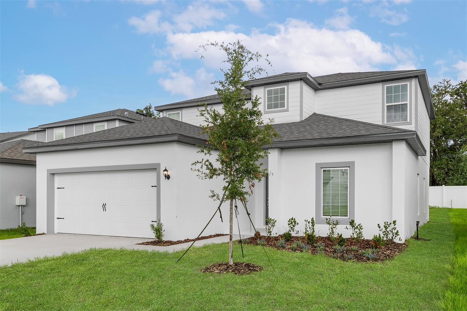 Pre-Construction. To be built. Step into comfort and style with the Useppa model, a spacious two-story, 5-bedroom, 2.5-bathroom home located in the welcoming Tula Parc community of Astatula, FL. Designed with space, function, and modern features in mind, this move-in-ready home is perfect for families of all sizes.
Enjoy an open-concept main level that seamlessly connects the spacious family room, chef-ready kitchen, and large dining area—an ideal layout for entertaining and everyday living. The kitchen comes fully equipped with energy-efficient Whirlpool® appliances, granite countertops, designer wood cabinetry with crown molding, LED flush-mount lighting, and a walk-in pantry.
Upstairs, you’ll find all five bedrooms, including a flex room and a game room offering plenty of space for work, play, or relaxation. The luxurious master retreat features a huge walk-in closet, dual sink vanity, and a step-in shower for a spa-like experience at home.
This home is filled with upgrades, including luxury vinyl plank flooring, a programmable thermostat, double-pane low-E vinyl windows, and a Wi-Fi-enabled garage door opener. Curb appeal shines with mature front yard landscaping and a covered front entry.
Located just minutes from Little Lake Harris and the Chain of Lakes, residents can enjoy endless outdoor activities such as boating, kayaking, and fishing. The Tula Parc community also features a gazebo and playground, and you’re only a short drive from Orlando’s world-class shopping, dining, and attractions.
Don’t miss your chance to make the Useppa model your new home—schedule a tour today and experience everything it has to offer!