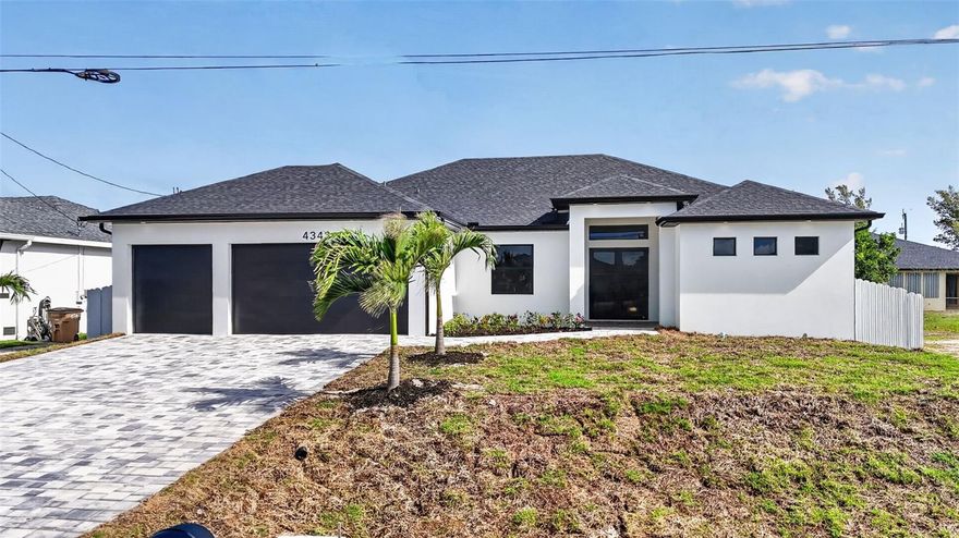 This stunning new construction residence offers the perfect blend of modern design and Florida lifestyle living. Situated on a high-elevation lot for added peace of mind this home features 3 bedrooms + den, a 3-car garage, a fully fenced backyard and a paver-lined driveway framed by lush palms. Step inside and experience a bright, airy atmosphere enhanced by sparkling porcelain tile throughout, tray ceilings, and an open-concept layout designed for both everyday living and entertaining. The showpiece kitchen delivers a true “wow” factor with sleek European-style cabinetry, pristine white quartz countertops, and a dramatic waterfall island overlooking the main living area and pool. The outdoor space is a true Florida retreat—featuring a beautifully designed pool, expansive paver deck, generous covered lanai with contemporary fans, and ample room to create your dream outdoor kitchen. Additional upgrades include impact windows and doors, custom California-style closet systems, tankless water heater, and an epoxy-coated garage floor. Located just minutes from Crystal Lake Park, the vibrant waterfront charm of Matlacha, the laid-back island lifestyle of Pine Island, and the highly anticipated Seven Islands Project—plus a short drive to the walkable downtown of Punta Gorda—this home places you at the center of Southwest Florida’s most exciting growth corridor. Modern, elevated, and effortlessly stylish—this is Northwest Cape Coral living at its finest.