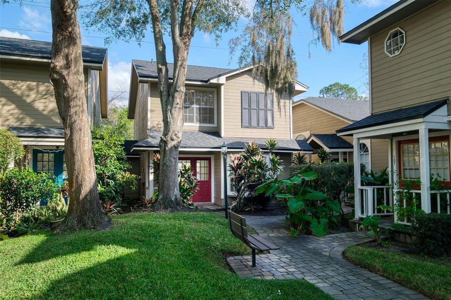 Welcome to this charming two-bedroom, two-and-a-half-bathroom townhome offering 1,309 square feet of comfortable living space in the quaint community of Lakeview Village. As you approach the home through a welcoming courtyard and brick paved walkway, you will find this home features a rare dual primary suite layout, providing privacy and flexibility ideal for roommates, guests, or multigenerational living. Fresh new interior paint completed in December 2025 and brand-new carpeting installed the same month give the home a clean, modern feel. Ceiling fans, new toilets(added in December 2025), blinds throughout, and a sliding glass door enhance both comfort and functionality. The open living and dining room layout creates a spacious atmosphere perfect for everyday living and entertaining, while a convenient laundry closet includes a washer and dryer for added ease.  The kitchen features warm wood cabinetry and a bay window that fills the space with filtered light, creating a bright and cheery environment for cooking and gathering. The thoughtful layout allows for seamless flow between the kitchen, dining, and living areas.  Each primary suite offers generous closet space, including two closets in the main suite, along with ceiling fans and private en-suite bathrooms. The primary bathroom is well-appointed with a double vanity, a tiled walk-in shower, and a separate shower and water closet area, offering both comfort and privacy.  The second primary suite offers an expansive vanity and tub/shower combination.  The exterior features add to the home’s appeal with a private entrance and a rear patio accessed through sliding glass doors. A deeded parking spot provides convenient and assigned parking.  Residents of Lakeview Village enjoy access to a variety of community amenities, including a clubhouse, swimming pool, tennis court, and a fishing dock on scenic Lake Frederica. Ideally located just 13 minutes from Orlando International Airport and close to shopping, dining, and everyday conveniences, this home offers a perfect blend of comfort, location, and lifestyle.