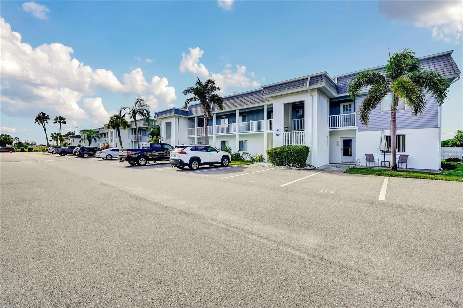 Discover the pinnacle of coastal living in this exceptional 2-bedroom, 2-bathroom ground-floor condo in the vibrant Edgewater Village community. This end-unit truly stands out with unique features: east-facing bedroom windows that flood the space with natural light, a rarity among other units; direct ground-floor access to two private outdoor patios, with the backyard patio providing a secluded retreat, perfect for grilling and entertaining, seamlessly paired with the extra square footage under air conditioning from the finished lanai, complete with large windows showcasing the backyard and inviting even more light. Edgewater Village offers resort-style amenities with low condo fees covering access to a sparkling heated pool, tennis, pickleball, bocce, shuffleboard, and a variety of community activities. Located just 1.5 miles from the Sunseeker Resort and across the Peace River from Punta Gorda’s charming historic downtown, you’re steps away from top restaurants, boutique shopping, medical facilities, and vibrant local events. Enjoy the beach just 35 minutes away, with Punta Gorda Airport only 15 minutes away for easy travel. Plus, catch Rays spring training baseball games just 15 minutes away or Braves spring training games 30 minutes away. Keep your eyes on the pool from your front patio, only steps away. You'll also enjoy the mature trees, blending convenience with serenity. Don’t miss this move-in-ready condo with unmatched style, space, and location in Punta Gorda!