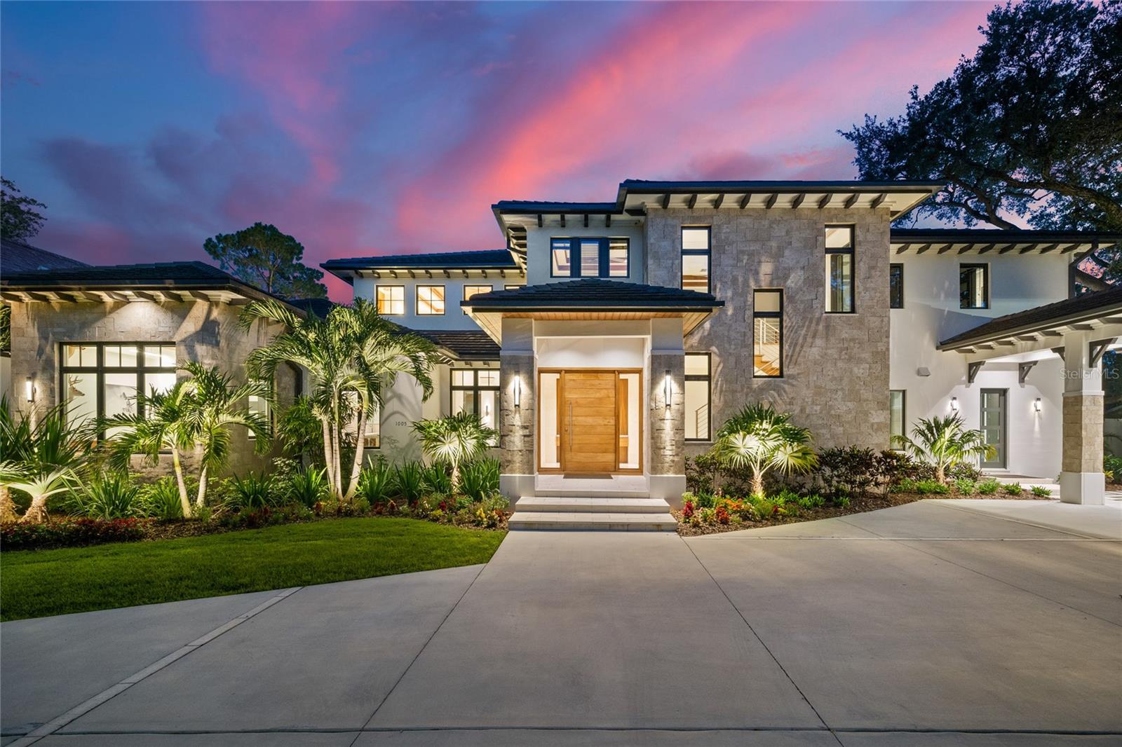 1005 Siwanoy is a rare opportunity to own a newer construction, move-in ready home located on the 17th fairway of Palma Ceia golf course. Designed by architect Meyer Weitzman and built by John Sample Properties who worked closely with the homeowner to design a truly custom and unique home that reflects the homeowners passion for contemporary design married with the warmth and character of high end Caribbean resorts. Enter the home into a custom designed foyer with art gallery wall into the expansive family room with soaring 25 foot ceilings. 10-foot folding Euroglass wall highlights the expansive view of the golf course to the Palma Ceia clubhouse. Highlighting the family room is a 23’ foot coral fireplace wall flanked by custom walnut bookcases. The downstairs master suite features a private office, enormous bathroom with his and her custom walnut vanities, separate his and her showers, closets, and free standing tub. The double island kitchen design with custom walnut cabinetry, massive walnut dropped soffit with recessed lighting and custom pendants, sleek Jenn-Air appliances, and walk-in pantry will delight the homeowner who loves to entertain! Relax in the expansive den featuring a pool table, fireplace, separate bar area with a walk in chilled wine closet with custom walnut shelving to display the discerning collectors favorite bottles. The entertaining continues outside with a large covered terrace with soaring fireplace wall, outdoor wall mounted TV, outdoor summer kitchen and custom designed pool and rimless spa. Upstairs features 4 bedrooms with custom designed en-suite bathrooms and large bonus room with double gaming zones. Built to the highest standards of construction with cast in place concrete, Eldorado Stone coral finished concrete accents, custom linear gutters, impact windows, Creston home automation, electric window coverings and so much more! (See attachment for complete list of home details). With its exquisite design and rare golf course location, it presents a fantastic opportunity for those seeking to live in the heart of one of Tampa’s most coveted locations.