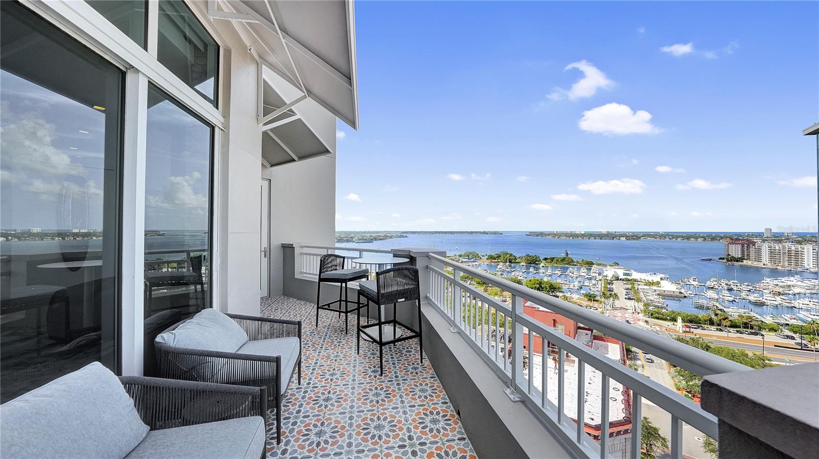 Welcome to your exclusive downtown oasis, “The One at 1350 Main”, a Penthouse residence perched on the 17th floor, boasting breathtaking panoramic views of downtown, Sarasota Bay, and the Gulf of Mexico. Built in 2007, this meticulously remodeled residence offers the epitome of city living with an impressive three bedrooms, and a sprawling 3,208 square feet of interior space. Step inside this modern masterpiece, and be instantly captivated by the open layout, accentuated by walls of floor-to-ceiling glass that bathe the home in natural light and frame the awe-inspiring vistas. The impressive, custom plank high ceilings create a sense of grandeur, while the wood flooring adds warmth and elegance throughout the space. The heart of this penthouse is a chef's dream kitchen, thoughtfully designed with quartz countertops, custom cabinetry by Irpinia, and top-of-the-line Wolf and Sub-Zero appliances. Gather with friends and family in the inviting media room, where the Sonos surround sound system ensures a captivating entertainment experience. Every detail has been carefully considered, from the programmable Ketra smart home lighting system to the stylish mix of wood, brick and glass finishes that exude sophistication and timeless appeal. Retreat to the lavish master suite, offering an oasis of tranquility with its private sanctuary and spectacular views. This secluded getaway also includes a massive walk-in closet with plenty of built-ins, gorgeous spa-inspired en-suite bathroom, and private access to the largest of two terraces. Two additional, generously sized bedrooms provide ample space for guests or can be repurposed into a home office or fitness area, accommodating your specific lifestyle needs (the third bedroom is currently equipped with lush theater seating, convenient snack/candy bar, and is being used as a media room). Outside, two verandas await, providing a seamless indoor-outdoor living experience and the perfect backdrop for savoring Sarasota's enchanting sunsets. Relax in the warm Gulf breeze as you enjoy the ever-changing cityscape below. This premier downtown location allows you to walk to the best of city living, from world-class dining and shopping to cultural experiences and artistic pursuits. Embrace the vibrant energy of downtown Sarasota. Offered furnished and immediately move-in ready, this Penthouse residence is a rare opportunity to enjoy an exquisite piece of downtown Sarasota. With its unparalleled views, sophisticated design, and ideal location, this luxurious getaway epitomizes the essence of modern city living.