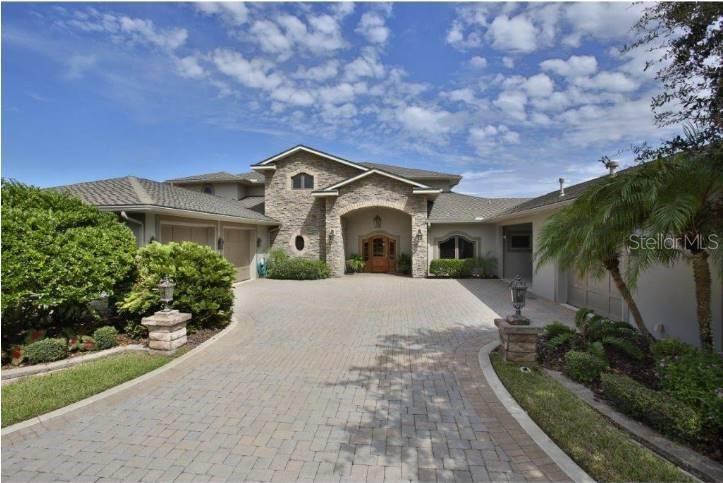 This elegant waterfront home is located on the Indian River/Intracoastal Waterway. The extraordinary, timeless estate sits on a sprawling 1+/- acre of land. Deep-water dock, IPE deck, boathouse and lift make Ponce Inlet or lagoon fishing access simple. This 2-story custom-built home, built in 2005 by local and well-respected builder Butch Frye, features 7,926 +/- total square feet and 5,347+/- square feet of air-conditioned space, utilizing the best techniques and materials. Construction is superb, with solid concrete construction on both levels, including a 22KW natural gas generator ready to provide backup power to the entire residence. Exterior doors and windows are Anderson “high impact” rated quality. Full house security system and cameras. This residence consists of four bedrooms and two and a half baths. The ground level presents expansive waterfront views from the dining room, living room, gourmet kitchen, breakfast nook, guest bath, family room and owner’s master retreat. The alluring master suite is located on the main level of the home, large his/her closets all with custom built ins, recessed lighting, garden tub, walk-in shower, double sinks, make-up vanity and two private walk outs to back patio and carport. The second floor provides two additional large guest suites, additional flex room and access to the large second level balcony with breath taking direct river and estuary views. Large, 36” wide mahogany doors, trim and crown molding are throughout the entire home providing an elegant finish. Not to forget to mention that the kitchen consists of Cherry cabinetry, granite countertops, 17.4’ x 6.2’ expansive walk-in pantry and all stainless-steel appliances including warming drawer and a Fisher Paykel five burner natural gas stovetop and built-in Miele coffee system. For business, the den/office has beautiful Cherry wood built-ins offering a sophisticated and well-polished executive office space. 3 enclosed garages (1 climate controlled) ;Water: City