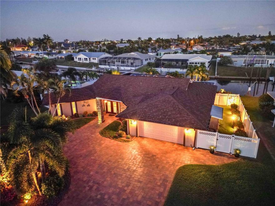 This stunning resort-style 3-bedroom, 2.5-bath canal-front pool home in Coral Shores embodies the ultimate Florida lifestyle. World Class Beaches, Fishing and Dining are all just moments away. Designed for both relaxation and entertaining, the property boasts a private boat dock with a 25,000-pound lift powered by two ¾-horsepower motors, along with updated cradle, bunks, and cables, plus a newer boat cover and framework. A composite deck with solar-lit pilings leads directly to the water.
The covered, screened lanai features motorized screens and a custom tongue-and-groove Cypress ceiling, opening to a newer solar-heated pool and spa with rock waterfall and multi-colored lights. The outdoor kitchen and entertaining area, complemented by landscape lighting and an outdoor Bluetooth sound system, create a true backyard oasis.
Curb appeal is exceptional, with a circular paver driveway and lush tropical landscaping, complemented by synthetic grass in the side yard- for easy maintenance. An oversized 2-car garage provides ample space for vehicles and storage.
Inside, the open living area seamlessly connects the dining, and kitchen. 
The spacious living room, featuring cathedral ceilings, opens through multiple sliding doors to the pool area, dock, and canal beyond, creating a sense of expansive indoor-outdoor living. The bright, airy kitchen boasts granite countertops and LG stainless steel appliances, including a 2023 Frigidaire Slide-in induction range. An extended countertop offers bar seating and flows naturally into the living and dining areas, connecting seamlessly to the screened lanai. Adjacent to the kitchen, the remodeled laundry room with half bath enhances functionality 
The remodeled primary suite, offers privacy, a large walk-in closet with organizers, and a luxurious bath. The grand guest bath was beautifully updated and features a dual sink vanity, impressive tile work, and an oversized shower with glass doors. Bedroom #2 is generously sized with built-in storage, while Bedroom #3 is ideal as an office or hobby room. Plantation shutters and wood-look vinyl flooring throughout add warmth and coastal elegance.
Meticulously maintained and unaffected by the 2024 hurricanes, this home offers peace of mind along with numerous upgrades including-   a new roof (2025), impact windows, and relined cast iron sewer lines (2020). The HVAC system and ducting were replaced in 2020 with a high-efficiency 16 SEER 2-stage condenser. Additional enhancements include a 50-gallon water heater (2020), Pentair IntelliFlo variable-speed pool pump (2021), blown fiberglass attic insulation (2021), and a generator switchover box (2024). The electrical box was also updated.
Outside, a hurricane-anchored 8x10 shed provides additional storage, and the outdoor irrigation system that keeps the grounds pristine year-round. Most furniture is available for separate purchase, as are the Boat and Hot Tub.
Located just three miles from Anna Maria Island and the Gulf of Mexico, and minutes from Sarasota, Longboat Key, Siesta Key, and Lido Key, with SRQ Airport only 11 miles away, this canal-front retreat blends elegant design, thoughtful upgrades, and resort-style amenities for truly carefree coastal living. Don’t miss your chance to own a slice of paradise—schedule your private showing today and experience the beauty of 4607 Bimini Drive for yourself.