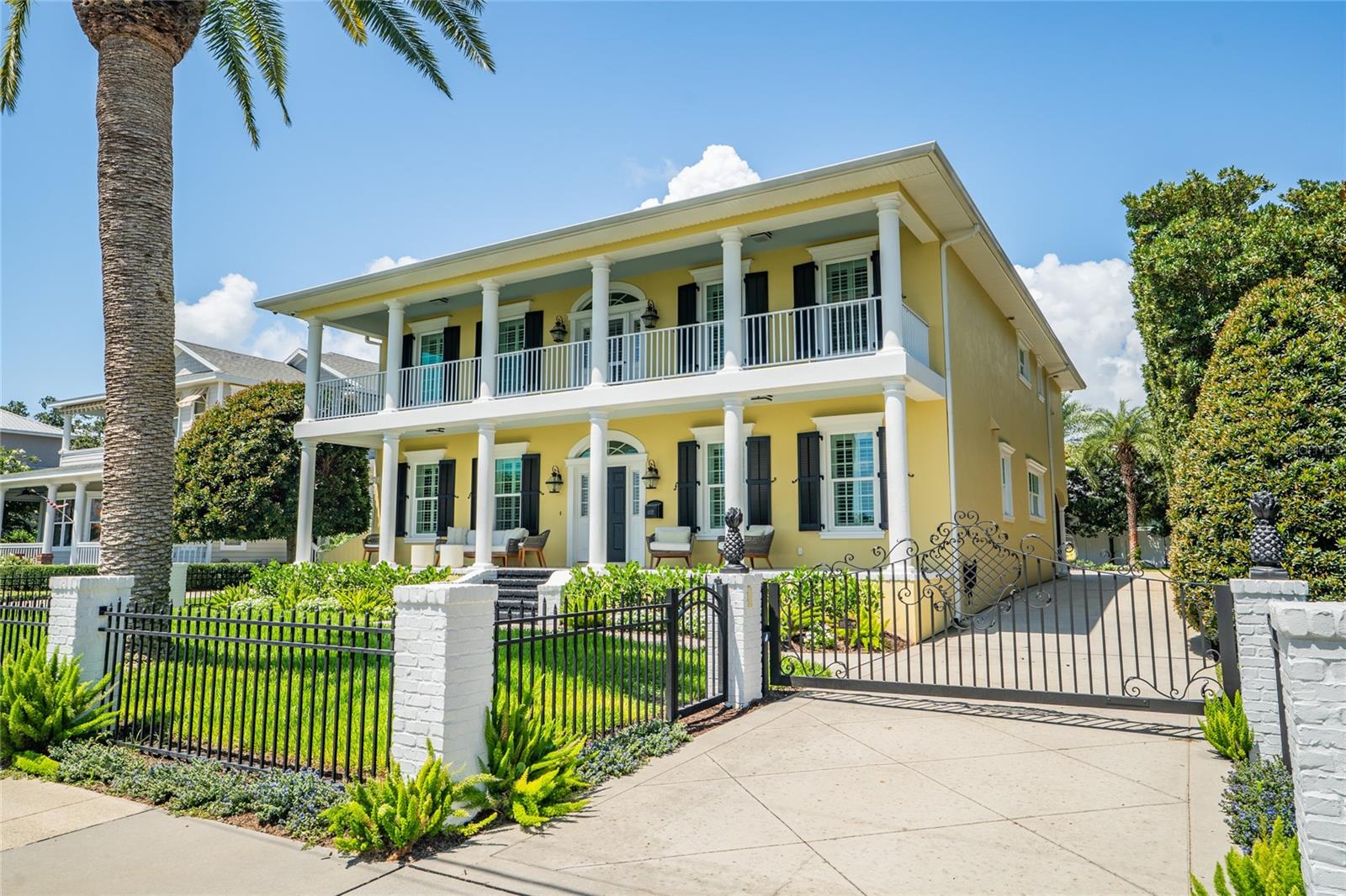 Discover a rare opportunity to own this exquisite custom-built residence in the prestigious Riverside Drive section of New Smyrna Beach. Offered fully furnished, this coastal estate is a waterfront masterpiece, showcasing sweeping views of the Intracoastal Waterway and a private two-slip dock with a boathouse and lift for vessels up to 7,000 lbs. Privately gated and impeccably maintained, the home was built in 2012 with exceptional craftsmanship and timeless architectural detail. From the moment you arrive, every element impresses—from the smooth stucco exterior, solid poured-concrete porches, brick-accented steps, custom fencing, and fiberglass colonial shutters to the commercial-grade gate operator ensuring secure entry. Inside, 4,653 square feet of refined living space includes five bedrooms, four full bathrooms, including a beautifully appointed in-law suite with its own kitchen, bath, living and dining areas, and private access through the garage or primary suite—perfect for multigenerational living or extended guests. The elegant interior begins with a formal dining room and a flexible space ideal for a home gym or office. White oak floors in custom lengths and widths flow throughout the open great room and casual dining area. The remodeled kitchen is a stunning focal point, featuring custom cabinetry, quartz countertops and backsplash, new designer lighting, a 48” SubZero refrigerator/freezer, 48” Wolf gas range, 24” Cove dishwasher with water softener, Thor beverage fridge, and pantry. A guest bedroom and full bath are also located on the first floor. Upstairs, two guest bedrooms are connected by a Jack-and-Jill bath, while the expansive primary suite includes a private office, spa-like bath with soaking tub and walk-in shower, an oversized custom closet nearly 20 feet long, and a private balcony overlooking the water. Comfort meets efficiency with closed-cell Icynene insulation in exterior walls and ceilings, added insulation between the main home and in-law suite, three interior laundry hookups, gas tankless water heater systems, and a fully fenced yard ideal for pets. From 2023 to 2025, the home was elevated with luxury upgrades, including two new HVAC systems, remodeled kitchen with quartz surfaces and premium appliances, updated lighting, fresh interior paint and wallpaper, new stair carpeting, frameless glass shower doors in all bathrooms, and a Hydroviv water filtration system serving the kitchen, kitchenette, and primary bath. Thoughtful additions such as custom mirror cabinetry with hidden storage, freshly stained dock boards, and a 24kW Generac whole-home generator (installed in 2024) enhance both comfort and functionality. In 2025, a brand-new cold plunge and completely redesigned front and rear landscaping created a serene outdoor oasis. A spacious three-car garage provides ample room for vehicles, watercraft, or hobby space. This exceptional residence is more than a home—it’s a statement of elegant coastal living, offering unmatched comfort, versatility, and proximity to Historic Canal Street and the Yacht Club. Schedule your private tour today to experience this waterfront treasure firsthand.