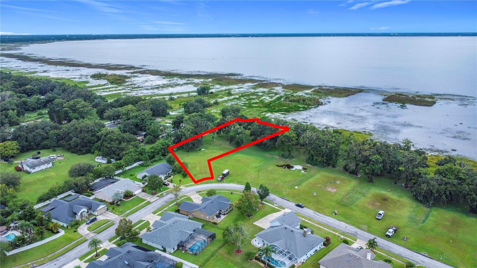 Welcome to your slice of waterfront paradise. Tucked inside the upscale, gated community of East Lake Reserve, this oversized lot spans over 1 acre, features a potential long private, discreet entry that broadens into an expansive lakeside sanctuary—providing ample room to design a luxurious custom home perfectly tailored to your lifestyle.
Enjoy direct access to East Lake Tohopekaliga, one of Central Florida’s most scenic and expansive lakes—perfect for boating, kayaking, fishing, or simply relaxing along the shoreline. Imagine waking to breathtaking sunrises over glassy waters and ending your day with golden sunsets from your future dock or backyard retreat.
Beyond its natural beauty, this location offers unmatched convenience—just minutes to vibrant Lake Nona dining, shopping, and top-tier medical facilities, as well as Orlando International Airport. Major highways, including 417, 528, and Florida’s Turnpike, are all within easy reach.
Under the shade of towering oaks, envision your private lakeside haven—complete with a pool, expansive patio, and custom dock. This is more than just a lot; it’s the starting point for your forever home on the water.