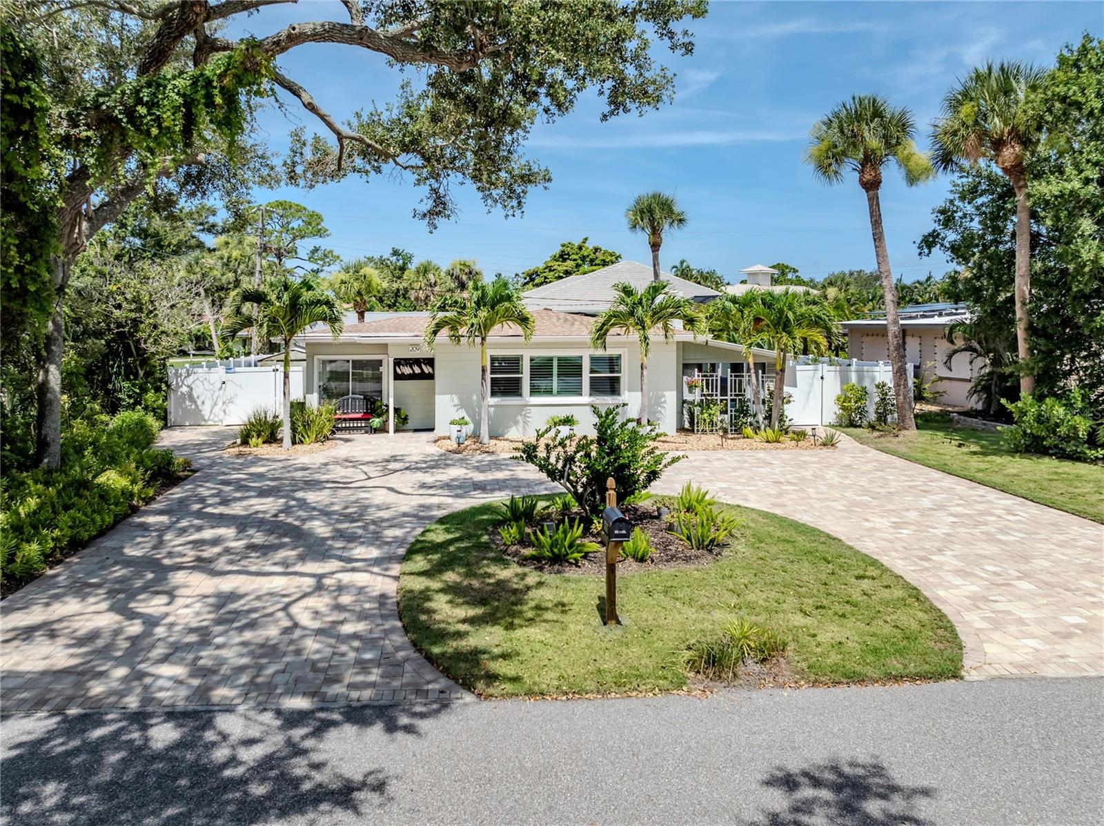 A trophy home of mid-century modern design that showcases luxury and sophistication awaits you. Welcome to your dream home in the heart of beautiful and world-renowned Venice Island. This charming residence provides a blend of comfort and coastal living with luxury vinyl light wood plank floors and tile throughout. With its prime location just minutes from stunning Gulf beaches, vibrant downtown Venice with a variety of shopping and dining options, this property is a gem. Go inside to discover a spacious and inviting layout featuring two bedrooms and two baths ideal for families or those seeking a serene retreat. The open-concept living area with a fireplace and built-in bookshelf is bathed in natural light, creating a warm and welcoming atmosphere. The modern renovated kitchen boasts quartz countertops, under-mount sink, GE stainless steel appliance suite with built-in stove hood, glass tile backsplashes, neutral color 42-inch tall cabinets, brass hardware and decorative glass shelving, making it a chef's delight. Enclosed Florida rooms with an abundance of windows create an opulent workspace for a home office, art studio or flex room left to the imagination to create. The primary bedroom is a gracious size with two walk-in closets, a private updated bath with a walk-in shower, glass partition, recessed lighting and a designer-inspired tile theme. The second updated bath is tastefully designed with coastal color and tile patterns, with a desirable walk-in shower. Outdoor space is abundant at this exceptional property. A screened patio with textured cement floor leads way to a new paver outdoor patio with a lighted pergola. A vinyl privacy fence surrounds the entire backyard, creating a private space for entertaining or simply relaxing in the Florida sunshine. Impact hurricane windows and doors are installed, adding an element of safety and mindfulness. Conveniently close to golfing, biking trails, shopping, restaurants, Interstate 75, airports, theater, cultural events, Wellen Park, Atlanta Braves spring training ballpark, nature parks and on the Island of Venice with treasured beaches presenting 14 miles of open coastline. Enjoy, explore and experience an inspiring lifestyle of adventure, luxurious comfort and lavish entertainment that awakens the senses. Share the history and culture that will thrill you! Look no further.