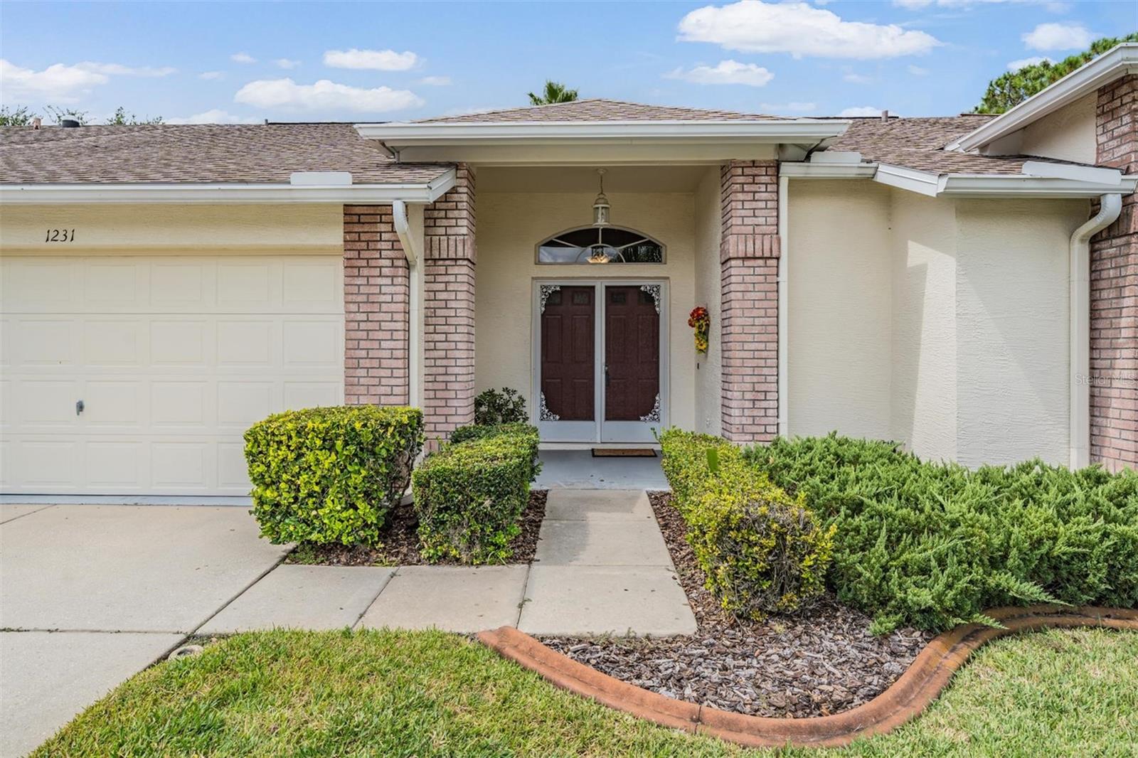 Enjoy stunning golf course views from your very own covered and screened lanai—a perfect place to relax and unwind. NEW ROOF 2016; NEW WASHER 2019; NEW WATER SOFTENER 2022; NEW CARPET 2022; NEW GARAGE DOOR OPENER 2022; NEW A/C 2025. Inside, the oversized great room offers an open, airy feel with engineered hardwood floors and a large picture window that fills the space with natural light while showcasing the lanai and golf course beyond. The remodeled kitchen is a true showpiece, featuring sleek stainless-steel appliances, a breakfast bar for casual dining, crisp white cabinetry, elegant Italian Carrara Marble countertops, and a cozy breakfast nook with views that make every morning special. Designer touches, including Travertine tile, add sophistication throughout the home. The thoughtful floorplan offers a large bonus space that could be a dining area or anything else you would like it to be. This area adjoins the great room, making entertaining seamless. A neutral color palette throughout provides the perfect backdrop for your personal style. Retreat to the expansive master suite, large enough for a sitting area, with a beautifully remodeled bath that boasts an oversized step-in shower. The secondary bedrooms are generously sized and designed to impress. Step outside and experience the comfort of the covered, screened lanai with peaceful golf course views—it’s the lifestyle you’ve been waiting for! 55 & FUN - LIVE THE HERITAGE SPRINGS LIFESTYLE - Resort style living at its absolute finest! Clubhouse with restaurant and bar, fitness, tennis, golf, cards, billiards, dancing and more! SUPERB TRINITY LOCATION, CLOSE TO BEACHES, DINING, SHOPPING, MEDICAL AND AIRPORT! Caution - Adults at Play!