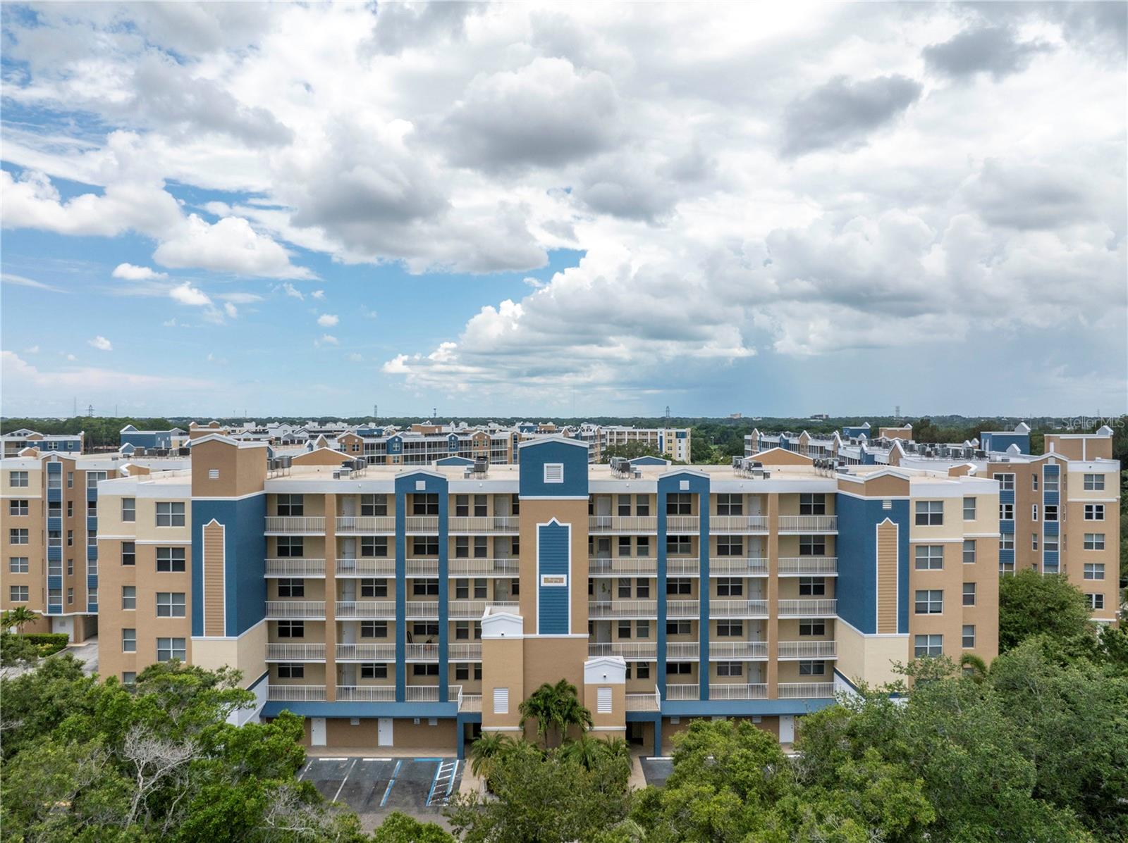 This beautiful 2 Bedroom, 2 full bath condo with a large eat in kitchen, and high ceilings, is only a 3-minute walk to the golf course and pools. The water view from the living room, primary bedroom and balcony allows owners a peaceful, quiet and in a wildlife setting. The huge primary bedroom also has a large bathroom, large shower, dual sinks, his and her walk-in closets and a walk out balcony. The condo has new carpet (July 2024) new paint, new ceiling fans, all new modern electrical switches and outlets, all new faucets and shut offs for water supplies throughout, new hot water tank (July 2024) and new AC unit on roof and in the unit (complete system 2025). The complex not only sits on a golf course, it has 2 large pools, one that is heated with a jacuzzi and a club house with a full kitchen and meeting room. This property is built out of solid cement, has sprinklers throughout, private elevator for each building (secure for only owners with key usage). This property is maintained and managed to the highest quality. HOA fees cover everything including cable TV, High Speed Internet, Insurance, trash, sewer, water, and maintenance of property and pools. Electric is only thing not covered. The building was totally repainted in the summer of 2023. Centrally located, close to airports, 3 different malls, grocery stores, restaurants, churches and 15 minutes to the beach! It is move in ready.