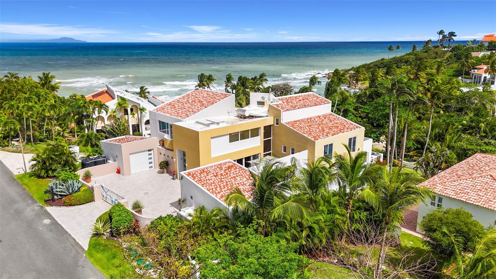 Experience exceptional island living with this rare oceanfront estate located in the exclusive Harbour View enclave of Palmas del Mar, Puerto Rico. This secluded and elegant compound sits on two adjacent lots, offering a one-of-a-kind combination of privacy, sophistication, and direct beach access.
Recently renovated with premium finishes throughout, the estate consists of a main residence and a spacious guest house—perfectly designed for luxurious coastal living, multigenerational families, entertaining, or income-generating potential. HOA $1,300/year CRIM/Property Taxes: $5514
Main Residence Highlights:
8,139 SF total (6,452 SF interior + 1,687 SF terraces)
Custom Italian porcelain floors and imported Italian doors
Lutron smart lighting system and Sonos sound throughout
4 bedrooms, 4.5 bathrooms including a stunning private owner’s suite with ocean-view terrace
Chef’s kitchen with Thermador appliances
Expansive living/dining area opening to outdoor terrace
Custom staircase and elevator
Hurricane-resistant windows
60KW generator with 300-gallon diesel tank
(2) 400-gallon water cisterns
Guest House Features:
2,532 SF interior
2 bedrooms, 2.5 bathrooms
Great Room, full kitchen, wine cellar, and storage
Storm shutters
Outdoor Paradise:
Heated saltwater pool and jacuzzi
Outdoor kitchen with BBQ, stove, sink, and dining space
Gazebo, firepit, lush landscaping
Direct access to a secluded beach
Live the Palmas lifestyle with access to golf courses, tennis courts, an equestrian center, pre-k to 12th school, marina, yacht club, and world-class dining—all within 40 minutes of San Juan.
Additional Highlights:
Move-in ready
Seller financing available
Seller accepts cryptocurrency
Motivated seller. This is a once-in-a-lifetime opportunity to own a tropical retreat that blends exquisite design with unmatched natural beauty and amenities.