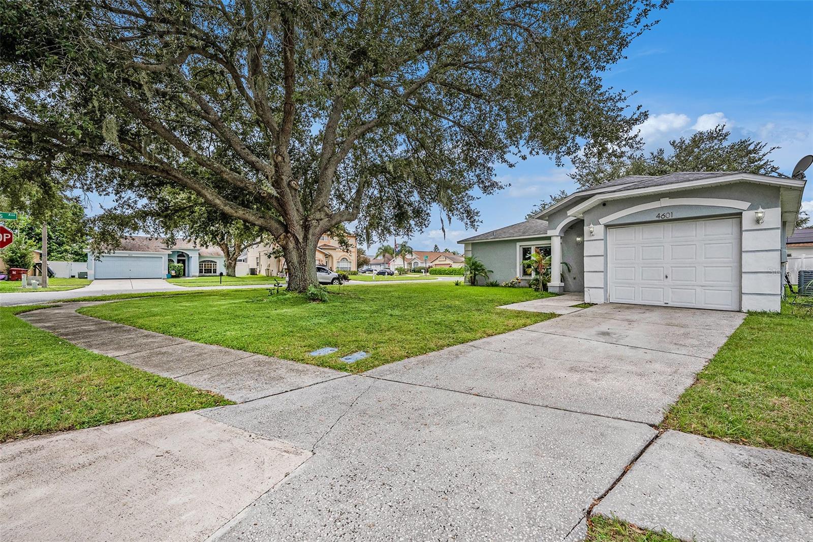 Unbeatable financing on this adorable home! 100% financing available and a 3.99% rate with just 3% down! This tastefully updated 2-bedroom, 2-bath block construction home sits on a spacious corner lot and offers comfort, charm, and affordability. Step inside to find a bright and airy family room with vaulted ceilings, creating a warm and inviting atmosphere. The split floor plan provides added privacy, with both bedrooms featuring their own updated bathroom, large walk-in closets, and natural light. The updated kitchen features butcher block countertops, white wooden cabinetry, white subway tile backsplash, stainless steel appliances, pantry, butcher block breakfast bar, and a window at the sink overlooking the backyard and lanai. One highlight of this home is the 480 square feet of year-round outdoor Florida living space provided by the screened lanai—perfect for relaxing, entertaining, or watching the family play in the yard and on the playset. With vinyl flooring throughout, this home is completely carpet-free for easy maintenance. This home is move-in ready and waiting for its next owner to enjoy all it has to offer. Don’t miss out on this Plant City gem in the Country Hills neighborhood!