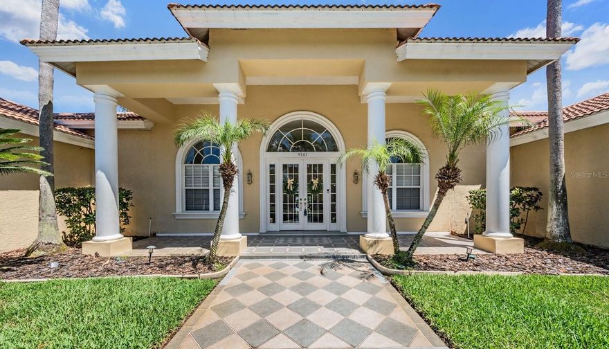 This uniquely designed custom Estate home in Robinwood at Lansbrook blends timeless architectural detail with peaceful pond and wooded views to create a truly private retreat. Thoughtfully designed with a split floor plan, the home offers 3 bedrooms plus an office with potential to be 4th bedroom or guest suite with French glass doors. Soaring ceilings, expansive windows, and abundant natural light enhance the open layout while showcasing tranquil views of the pool, pond, and surrounding wildlife. The updated kitchen features custom cabinetry, quartz countertops, stainless steel appliances, and a spacious breakfast nook overlooking the lanai and water views. The kitchen flows seamlessly into the inviting family room with a gas fireplace, creating an ideal space for everyday living and entertaining. The spacious primary suite offers elevated ceilings, a separate sitting area overlooking the pool and pond, dual walk-in closets, and a beautifully renovated spa-inspired bath complete with custom vanities, soaking tub, oversized shower, and built-in sauna. On the opposite side of the home, two additional updated bedrooms each feature their own bathrooms and direct access to the pool area. Resort-style outdoor living is equally impressive with a large screened lanai, tropical landscaping, private wooded backdrop, and serene pond views backing up to conversation/pond with no rear neighbors! A rare 4+ car garage provides exceptional space for vehicles, storage, hobbies, or recreational equipment. Numerous recent upgrades include renovated kitchen and bathrooms, luxury waterproof flooring, new carpet and tile, updated lighting and ceiling fans, newer front doors, rescreened lanai with pet-proof lower screens, pool heater, saltwater chlorinator, sprinkler system updates, water heater, hurricane shutters, and more. Lansbrook residents enjoy an exceptional lifestyle with miles of walking trails, parks, lakes, and access to the private Lake Tarpon park featuring a boat ramp, day slips, waterfront pavilion, playgrounds, and restrooms. The community also offers a sports park with basketball and soccer fields, nearby golf, highly rated schools, and convenient access to shopping, dining, beaches, and Tampa International Airport. With its extensive updates, flexible layout, tranquil setting, and exceptional Lansbrook amenities, this move-in ready home offers the perfect blend of luxury, comfort, and Florida lifestyle living.