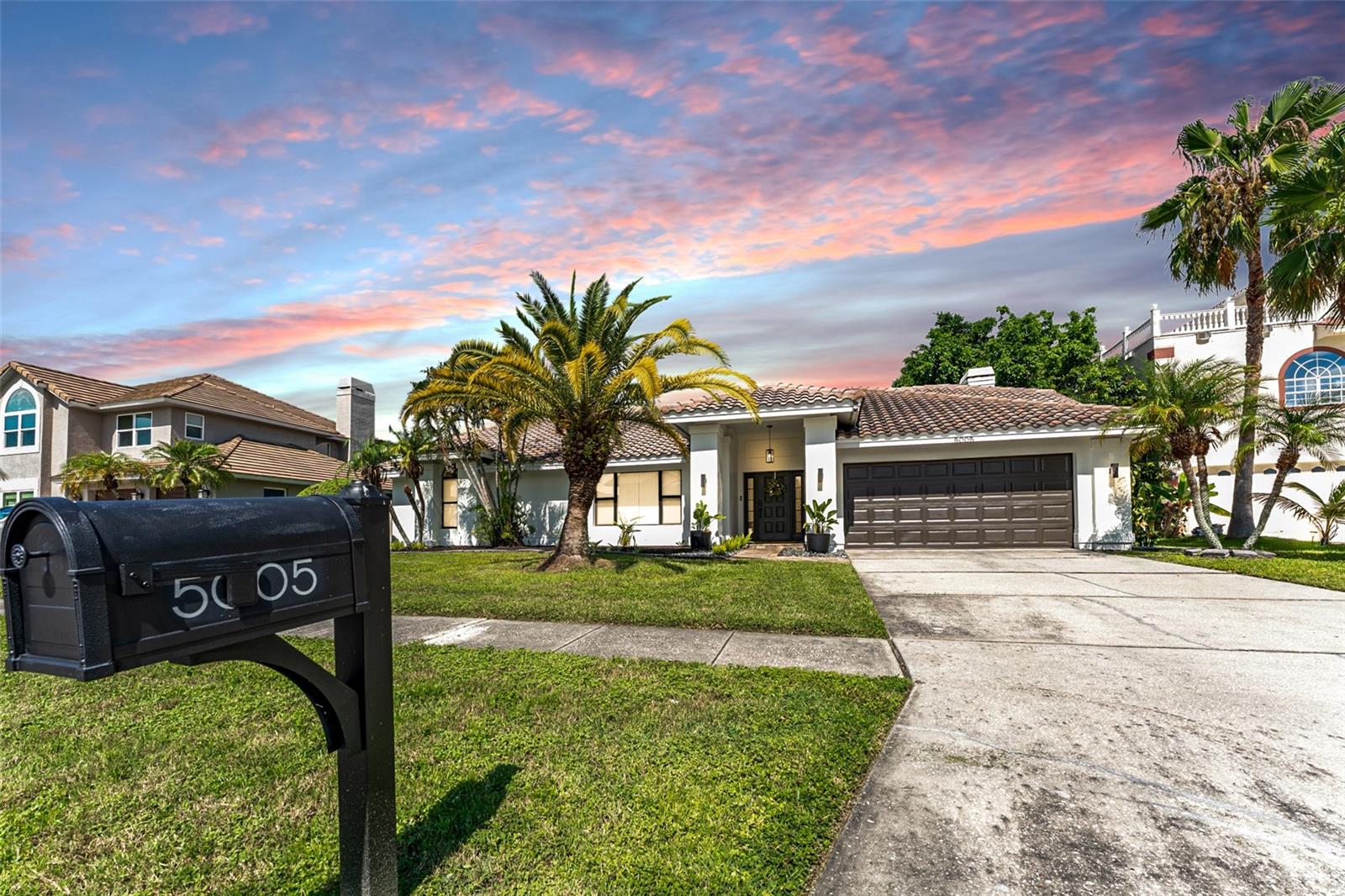 Welcome to 5005 E Longboat Blvd, an impeccably remodeled pool home offering the perfect blend of modern luxury, thoughtful design, and prime location. Situated in a quiet, well-established neighborhood just minutes from the heart of Tampa, this home has been completely updated inside and out—truly move-in ready and designed to impress. As you arrive, you’re greeted by a freshly painted exterior, lush new landscaping, and a wide driveway offering ample parking. Step inside to discover a bright, open-concept layout filled with natural light and high-end finishes. The entire interior has been freshly painted in a modern neutral palette, complementing the brand-new hardware, stylish light fixtures, and updated ceiling fans throughout. Every inch of this home has been thoughtfully upgraded for comfort and style. The chef’s kitchen is the centerpiece of the home, featuring gorgeous quartz countertops, a custom tile backsplash, and brand-new stainless steel appliances. A wet bar with a wine fridge adds a sophisticated touch and makes entertaining a breeze. Adjacent to the kitchen, the spacious living room is anchored by a striking stone and wood-burning fireplace—a rare and charming focal point that brings warmth and character to the space. This home offers four generously sized bedrooms and two fully remodeled bathrooms, both designed with comfort and sophistication in mind. The bathrooms feature beautiful quartz countertops, elegant porcelain tile flooring, and modern vanities with premium fixtures. The primary suite includes a spacious en-suite bath with dual sinks, providing added functionality and a spa-like feel. Whether you're hosting guests or winding down in your own space, you'll appreciate the thoughtful layout, high-end finishes, and seamless flow throughout every room. Step outside and discover your own private backyard retreat. The screened-in pool area is perfect for year-round enjoyment and is complemented by a built-in outdoor kitchen and grill—ideal for weekend barbecues or evening dinners under the stars. A custom putting green adds a unique and playful element, perfect for entertaining guests or practicing your short game in your own backyard. The outdoor space is fully fenced, offering plenty of room for pets or children to play. In addition to its luxury upgrades, this home enjoys a prime location in Tampa with easy access to everything the city has to offer. You’re just 10–15 minutes from Downtown Tampa, Ybor City, Water Street, and the Channelside District, where you can enjoy top-tier dining, entertainment, nightlife, and cultural events. Sports fans will love the short drive to Amalie Arena and Raymond James Stadium, and frequent travelers will appreciate being just 15 minutes from Tampa International Airport. Commuters have convenient access to I-4, I-275, and the Selmon Expressway, putting all of Tampa Bay within easy reach. 5005 E Longboat Blvd is more than just a house—it’s a completely turn-key, resort-style home with thoughtful upgrades, ideal indoor-outdoor living, and a location that puts you near everything while still enjoying the tranquility of a residential setting. Whether you're a growing family, a professional working downtown, or simply looking for a beautifully updated home in one of Tampa’s most accessible areas, this property checks all the boxes. Schedule your private showing today and experience the best of Tampa living!