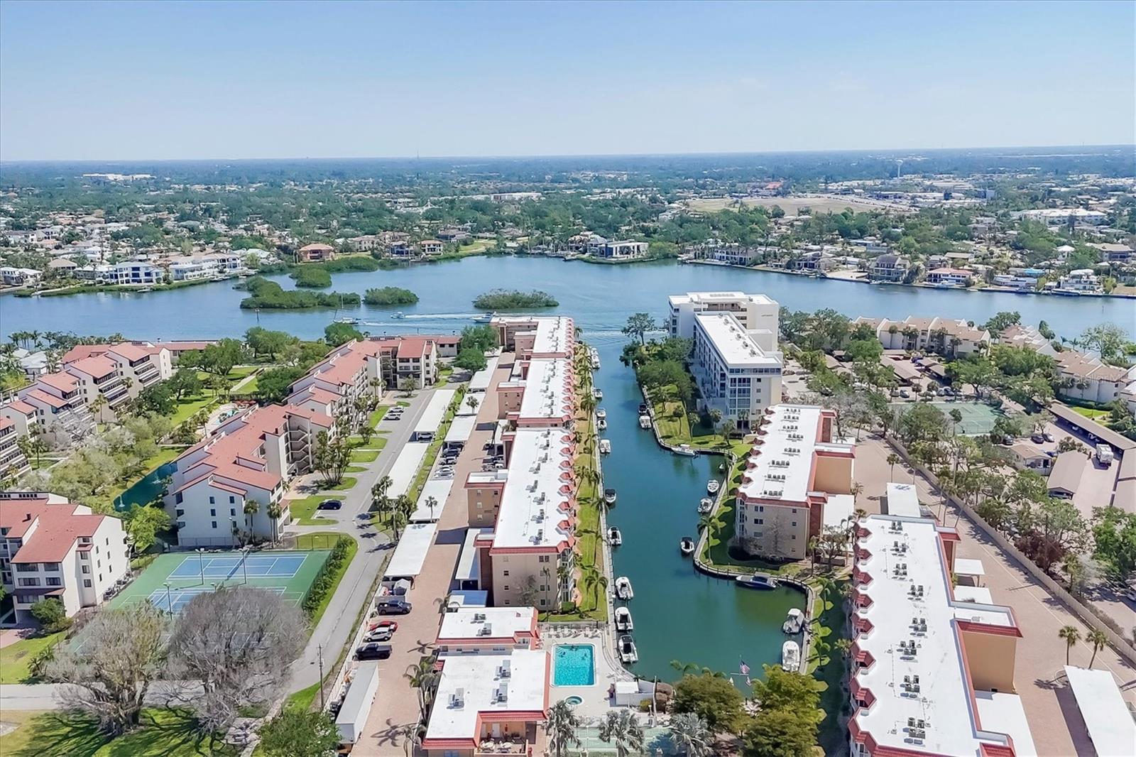 Wake up to sunrises over the marina, spend your afternoons boating or relaxing on the powdery sands of Siesta Key Beach, and unwind in the evening on your enclosed balcony, enjoying the tranquil views of the boats below and colorful evening skies. Located in Siesta Harbor, this furnished 1-bedroom, 2-bath condo offers a comfortable, coastal lifestyle just steps from the water. Beautifully updated and move-in ready, this residence features an open floor plan with luxury vinyl plank flooring throughout and expansive marina views that enhance the light and spacious feel of the home. The remodeled kitchen is equipped with granite countertops, white shaker cabinetry, glass tile backsplash, peninsula seating, and newer appliances —designed for both functionality and style. Furnishings were chosen with comfort and flexibility in mind, including a sleeper sofa for guests and a convertible desk/dining table. Both bathrooms have been updated with quartz vanities and tile showers. The guest bath includes a combination soaking tub and tiled shower. Impact windows and sliding glass doors provide added peace of mind, while the same-floor laundry and a private storage locker make everyday living more convenient. Siesta Harbor is a 55+ community which includes private access to Crescent Beach, a heated pool and spa, tropical landscaping, and a full social calendar with activities such as shuffleboard, billiards, happy hours, and fishing from the community pier. For boating enthusiasts, dock space may be leased (subject to availability) and can accommodate vessels up to 30 feet. Additional community features include covered parking, a full-time on-site manager, and a new roof (2025). Located just off the South Bridge, the property is within walking or biking distance to restaurants, shops, and entertainment — and easily accessible via the free Siesta Key trolley, perfect for effortless island transportation. Whether you’re seeking a seasonal getaway, full-time residence, or investment opportunity, this turnkey condo offers a relaxed waterfront lifestyle on Siesta Key.
