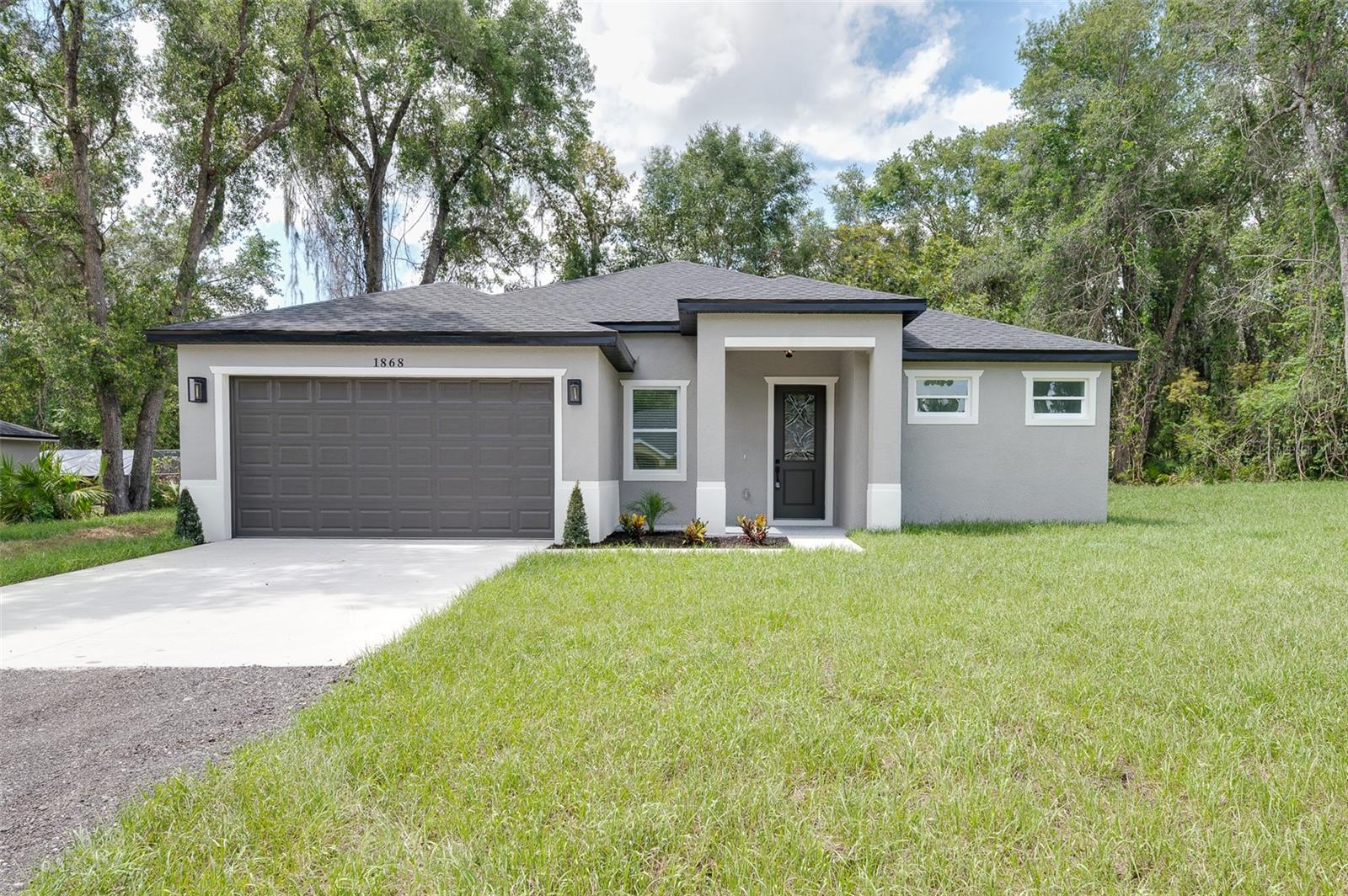 A Modern Oasis in Orange City, 1868 14th St, Orange City, FL 32763, 3 Beds | 2 Baths | 1,600 SqFt Living | 2,272 SqFt Total | No HOA or CDD
Step into elevated living with this brand-new, modern one-story masterpiece designed with exceptional style, comfort, and forward-thinking functionality in mind. Key Features That Set This Home Apart:
- 9'4" bearing walls – offering soaring ceilings and a true sense of openness
--Oversized 8' tall fiberglass front door – energy-efficient with zero heat transfer and high-end curb appeal
-Oversized 8' garage door – ideal for larger vehicles and modern convenience- EV-ready garage – pre-wired for your electric vehicle charger
-Vinyl double-pane Low-E windows – energy-saving, noise-reducing, and UV-protective
--3 spacious bedrooms & 2 luxurious bathrooms
- Gourmet kitchen with quartz countertops, large center island & stainless steel appliances
- Soft-close cabinets & bold modern black accents
- Elegant porcelain tile flooring throughout
- Private lanai with access from both the master suite and kitchen – the perfect indoor-outdoor retreat
- Recessed lighting, ceiling fans, and a spacious 2-car garage with opener
- Built with private well & septic – save significantly on utilities
- NO HOA / NO CDD fees – enjoy full ownership freedom!
LIMITED-TIME INCENTIVE:
The seller is offering exclusive assistance toward your closing costs—an incredible opportunity to save thousands, Located just minutes from I-4 and only 30 miles from Downtown Orlando, this home offers peaceful suburban living with quick access to the excitement of the city.
,Ready to tour this outstanding home.
Contact me today—this opportunity won’t last long! Ask for our list of new constructions homes.