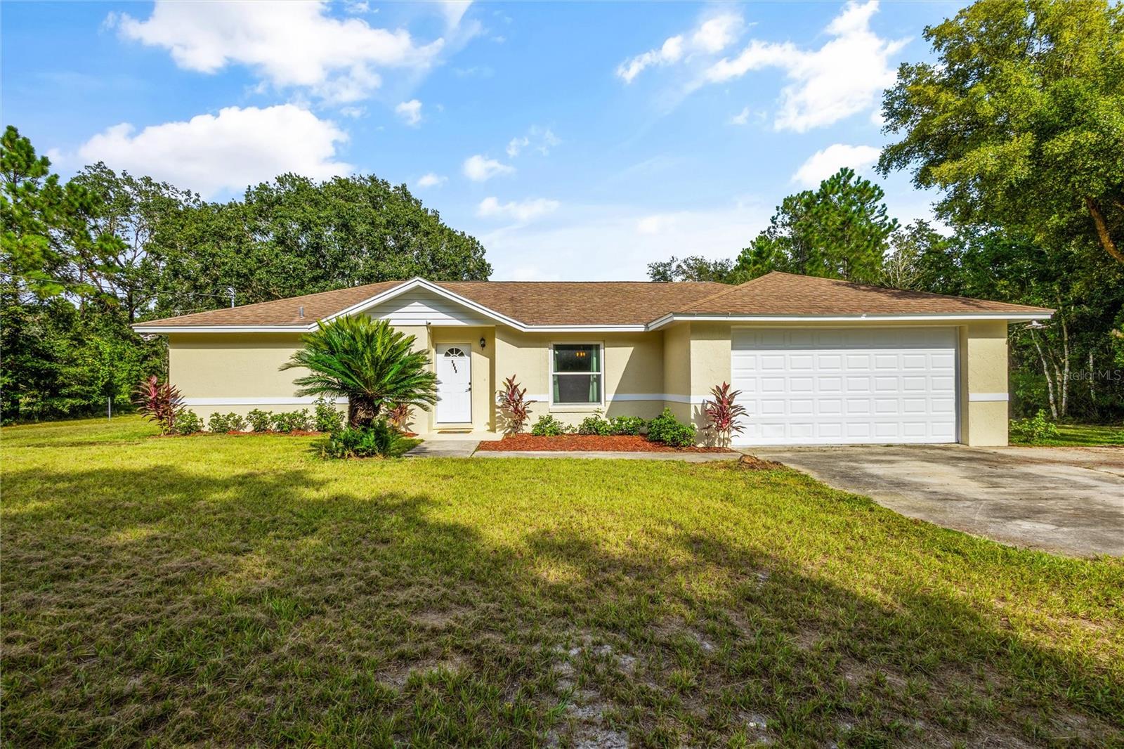 Nestled within the tranquility of over an acre of land, this RENOVATED concrete solid-built 4-bedroom, 2-bathroom home is a delightful blend of rustic charm and modern comfort in one of the fastest-growing cities in Florida, Saint Cloud! This home includes NEW HURRICANE STORM windows, 5 NEW HURRICANE PROOF sliding glass doors, NEW light fixtures, NEW never-used SMART stainless steel appliances, NEW vinyl flooring throughout the entire home, and NEW interior and exterior paint! ROOF is less than 10 years old! Its thoughtfully designed layout seamlessly connects the living room, dining area, and kitchen with an additional bonus family area. This home also includes an attached 2-CAR GARAGE. A standout feature is the versatile LARGE fully operational RED IRON framed STEEL panel WORKSHOP, perfect for hobbies, woodworking, or storing all your TOYS like extra vehicles, boats, ATVs, kayaks, RTVs, fishing gear, and much more! The extra space could also be used as an extra office or work space for BUSINESS OWNERS to have a home and business all on the same property! This unit also has a rolling steel door and has electricity already connected! There's also an additional hand-built custom wooden shed to match the home for added convenience. You also have the ability to rent out a part of your HUGE backyard. This home exudes a modern farmhouse-inspired character with this one-of-a-kind CUSTOM BUILT NEWLY RENOVATED KITCHEN featuring epoxy live edge counters, modern hardware, and brand NEW quality hardwood cabinets. You will also get to enjoy having PRIVATE LAKE FRONT ACCESS to Alligator Lake at the end of your private road. With TWO working wells, one septic tank, and no restrictive HOA or CDD, this property offers self-sufficiency and endless possibilities. Conveniently located near the Turnpike, 417, Disney, Lake Nona, Medical City, Orlando Airport, Orlando attractions, beaches, shopping, dining, and more, this home marries the tranquility of rural country living with the convenience of urban amenities. You will find not just a house but a lifestyle—a serene retreat on this private property that has not been lived in since its renovation! Schedule your viewing and make this RARE gem in a PRIME location your new home today!