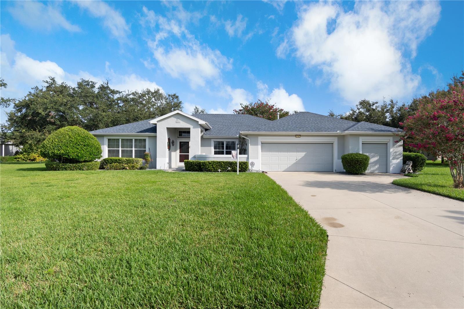 Prepare to be impressed by this beautiful 3-bedroom, 2-bath home located in the highly desirable Legacy of Leesburg community! From the moment you arrive, you’ll notice the extended driveway, lush landscaping, and the convenience of a 2-car garage plus a separate golf cart garage. A charming front courtyard welcomes you inside, where you’re greeted by a formal living room and a versatile flex space perfect for a home office or reading nook. The kitchen, truly the heart of the home, is a chef’s delight with stainless steel appliances, quartz countertops, a farmhouse sink, handsome backsplash, breakfast bar seating, and a cozy breakfast nook with sliding glass doors leading out to the screened lanai. The spacious primary suite features walk-in closets, dual sinks, a glass enclosed shower, and a linen closet. On the opposite side of the home, two additional bedrooms share a full bath one of which is currently set up as a custom home office with built-in desk and cabinetry. Step through the laundry room into the garage, where you’ll find not only two full size parking spaces and a golf cart garage, but also a large workshop with abundant storage for tools and equipment. The central vacuum system is also conveniently located here. Additional highlights include an oversized lot of more than half an acre and energy savings with a solar power system under an affordable, transferable lease.
Legacy of Leesburg is a gated, active-adult community offering an incredible lifestyle with walking trails, clubhouse, library, billiards, resort-style heated pool, social events, RV & boat storage, cable, internet, and lawn maintenance including. Conveniently located near major highways, shopping, and dining.