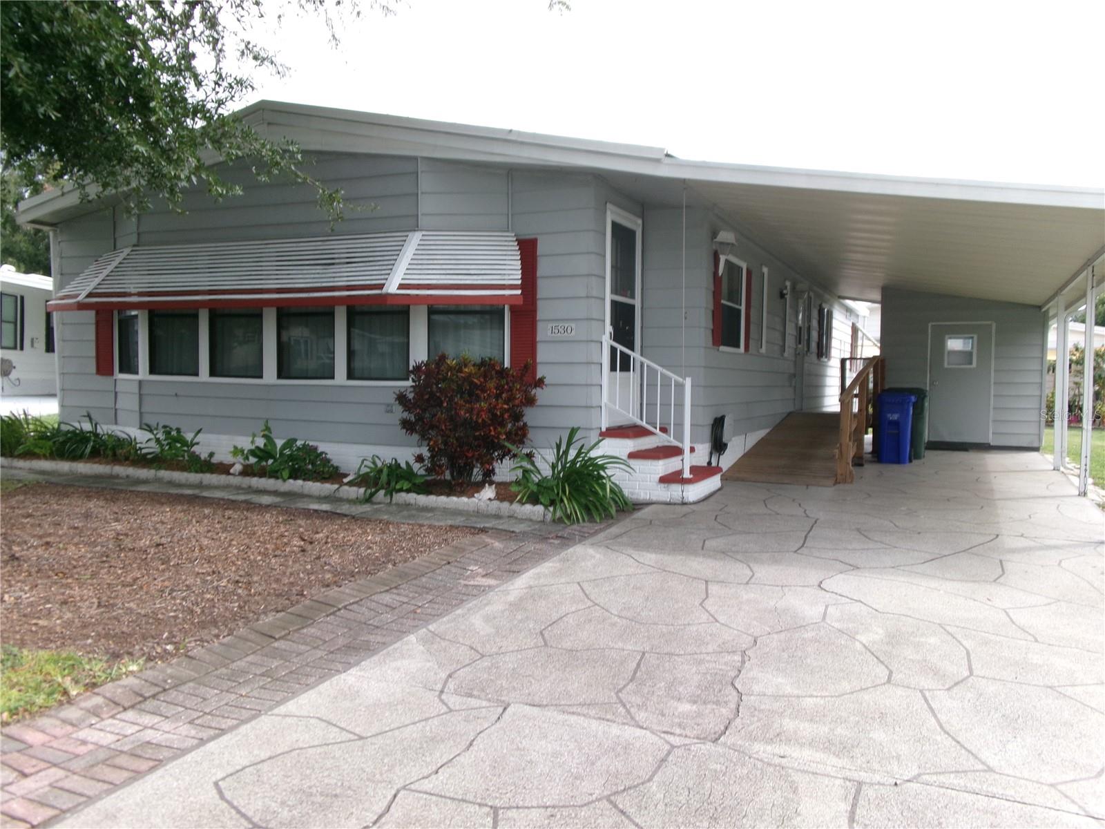 55+ Active Community Furnished Home that's ready to be your sunny winter home or year round residence! It is one of the larger homes in the neighborhood, over 1430 sq ft, with 2 bedroom suites, separate Living & Family rooms, many built-in cabinets, Large Dining area, Kitchen with closet pantry, breakfast bar & adjoining Dinette area, inside Laundry room, and a relaxing Florida Room/porch that has both screens & windows & separate AC. What more could you want? Oh, yes, the attached carport with room for your golf cart, and includes a convenient ramp entry to the home (or removable with stairs still there), and storage shed with workbench. This home has a Good condition 9 year old roof & 10 year old AC, and water filtration system recently serviced. The HOA is under $76 per month! The seller requests the sale to be SOLD AS-IS. Foxwood Lake Estates Senior community is quiet and friendly with so many amenities & activities: Heated community pool & spa, sauna, huge clubhouse, fitness center, library, shuffleboard & bocce courts, pickleball, billiards, a central lake with a beautiful fountain, surrounding walking trail & limited fishing is allowed. Golf carts are welcomed! The Social Club offers many activities to join: weekly bingo, weekly coffee hour, scheduled breakfasts & flea markets, crafts, cards, entertainment and much more. Such a fun place to live! Call to see it today!