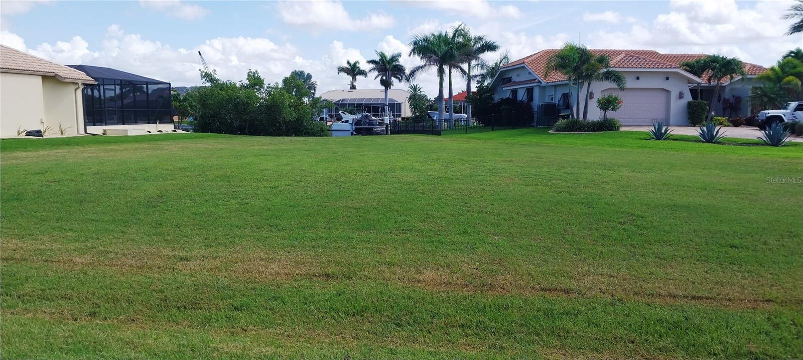 Sailboat Waterfront Lot in Punta Gorda Isles – Oversized with Wide Canal Basin View!
Build your dream home on this exceptional oversized lot in Punta Gorda Isles! Situated at the end of a quiet cul-de-sac, this property offers a peaceful setting and a stunning wide basin view along a deep-water sailboat canal. With 123 feet of street frontage and a concrete seawall already in place, there’s plenty of room for a spacious custom residence, pool, and possibly a 3-car garage.
Located in an area surrounded by beautiful, custom-built homes, this lot is ideal for those seeking a luxury lifestyle with direct access to Charlotte Harbor and the Gulf—no bridges, just a quick cruise via Buckley’s Pass or Ponce de Leon Park Inlet.
Enjoy close proximity to Fishermen’s Village, historic downtown Punta Gorda, waterfront parks, and scenic walking trails. Tee off at St. Andrews South Golf Club, or catch spring training action with five MLB teams just a short drive away. And for the outdoor lovers, world-class fishing, boating, and shelling in Boca Grande and Cayo Costa are minutes from your back door.
Whether you’re ready to build now or invest for later, this rare waterfront gem offers it all—space, location, views, and direct access to the Florida lifestyle you’ve been dreaming of. In Punta Gorda Isles, the City of Punta Gorda Canal Maintenance Division is primarily responsible for maintaining the seawalls. This includes the maintenance and reconstruction of bulkheads and retaining walls within the Punta Gorda Isles canal district. The division also handles seawall replacement, channel and inlet dredging, seawall stabilization, and mangrove trimming projects, often through outside contractors.