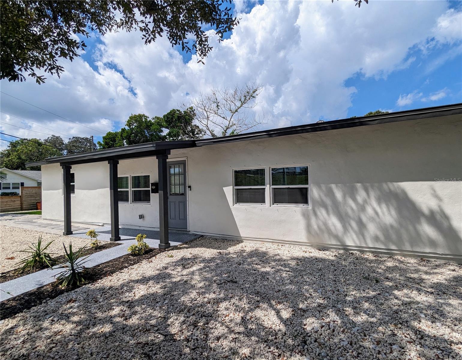 This beautifully renovated 3-bedroom 2 bath is ready to welcome its next lucky resident, boasting a host of fantastic updates that make it a true standout in the market. As you approach the property, you'll be greeted by lush, manicured landscaping that adds a touch of serenity and curb appeal to your new home. The front yard has been carefully designed to create an inviting atmosphere. The exterior of the home has also received a fresh coat of paint, providing an attractive and well-maintained facade that stands out in the neighborhood. As you step inside, you'll find a freshly painted interior that exudes a clean and modern feel. The neutral color palette enhances the sense of space and allows you to personalize the home to your taste. This property offers spacious living areas, perfect for both relaxation and entertaining guests. The open floor plan seamlessly connects the living room, dining area, and kitchen, creating a comfortable flow throughout the home. The kitchen has been thoughtfully updated with modern appliances, ample cabinet space, and sleek countertops, making it a pleasure to prepare meals and dine in style. The bedrooms feature ample natural light and generous closet space, ensuring that everyone has a comfortable place to unwind. The laundry room houses a brand-new washer and dryer and even has a tankless water heater that helps ensure that all storage space is being used. The fully fenced backyard even has a parking pad and electric gate! The turfed landscaping makes upkeep a breeze and provides a serene escape for outdoor activities, hanging out or simply enjoying the Florida sunshine. This property is situated in a convenient location, you'll have easy access to downtown Tampa, local amenities, shopping, dining, and entertainment options. Don't miss the opportunity to make 3200 22nd St N your new home. With its fresh landscaping, updated interior, and a location that offers the best of Tampa, this property won't last long. Contact us today to schedule a viewing and experience the charm of this newly renovated gem for yourself.