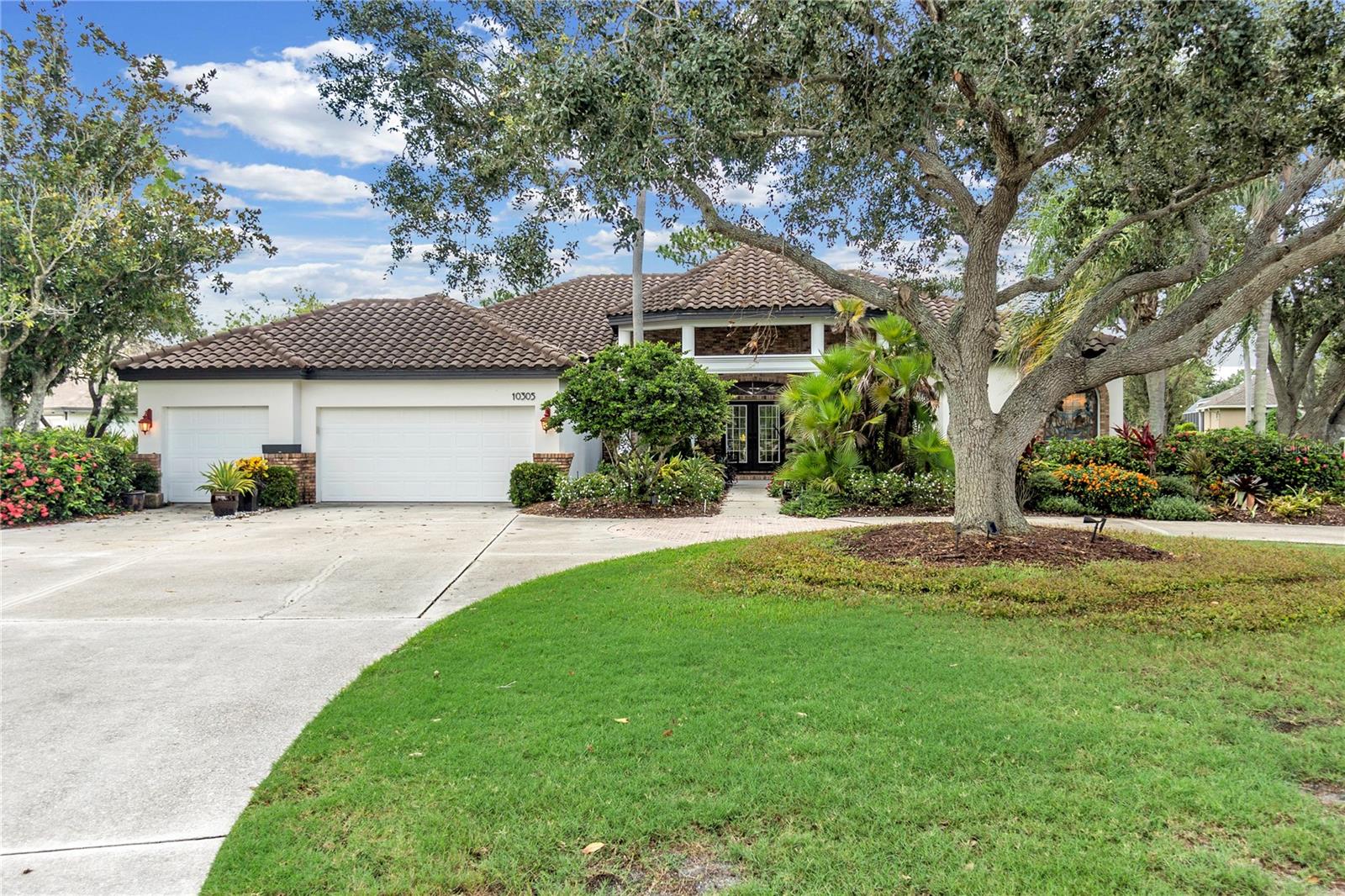 Discover effortless charm and true move-in readiness at 10305 Tamo Shanter Place, a custom-built former model residence beautifully sited on nearly three-quarters of an acre with serene views of the pond, preserve, and 16th fairway. From the moment you arrive, the covered entry and park-like grounds set the tone for easy Florida living. Inside, soaring ceilings frame a seamless blend of wood and tile floors, guiding you through a light-filled open layout where the oversized family room—with its cozy fireplace and wall of sliding glass—flows naturally to the extended, caged lanai.
Step into your private resort: an in-ground, self-cleaning heated pool and spa, surfaced in Pebble-Tec, surrounded by tropical plantings for year-round privacy. The adjacent gourmet kitchen shines with rich wood cabinetry, gleaming quartz countertops, stainless-steel appliances, and a sunny breakfast nook—ideal for casual meals or morning coffee. When it’s time to unwind, the serene primary suite offers a quiet sitting area, a generous walk-in closet, and a spa-inspired bathroom.
Two additional bedrooms, a private study, and two full baths provide flexible space for guests, remote work, or a home office, while formal living and dining rooms accommodate elegant entertaining. Practical perks abound—including a three-car, air-conditioned garage with extra storage, a tile roof replaced in 2018, and a new AC system installed in 2021—so you can truly move in and enjoy.
Nestled in The River Club—an upscale, deed-restricted golf community with low HOA fees, no CDDs, and top-rated schools—this turnkey home is just minutes from Lakewood Ranch Main Street, Waterside, the hospital, I-75, and the Gulf Coast’s finest beaches. Priced to sell and ready for its next chapter, there’s nothing left to do but start living the Florida lifestyle you’ve been dreaming of. Schedule your private tour today!