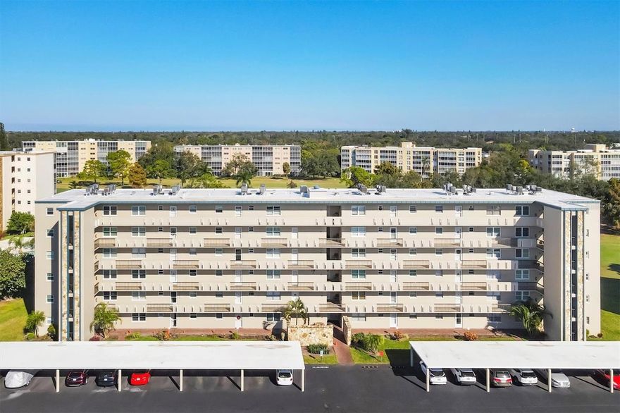 One or more photo(s) has been virtually staged. Experience premier 55+ living with direct golf course view. Welcome to your serene retreat in the heart of the desirable Ironwood community. This charming 2-bedroom, 2-bathroom first-floor condo unit offers an unparalleled lifestyle, directly overlooking the lush green fairways of the Pinebrook/Ironwood Public Golf Course. Step inside to an inviting open concept living and dining area, perfectly positioned to capture captivating views of golfers and local nature right up close. The space flows seamlessly into a bright, glass-enclosed lanai featuring sliding doors, designed to provide a wonderful year-round cross breeze and extended living space. The eat-in kitchen is both functional and stylish, boasting updated wood cabinetry, sleek Corian countertops, and newer appliances. The main bedroom suite serves as a private sanctuary, complete with a dedicated bathroom and a generous walk-in closet. A second bedroom and bathroom are thoughtfully situated to give maximum privacy for visiting guests. Convenience is key with a covered, deeded carport (#31) just steps from your front door, assigned storage locker on the 3rd floor, and a community laundry room conveniently located mid-building near the elevator. Significant updates include a newer roof (on both the building and carport) and updated plumbing, ensuring peace of mind. Resort-style amenities are just a short stroll away. Enjoy the clubhouse and heated pool right next door, or take advantage of the public golf course, tennis/pickleball courts, shuffleboard, and fitness area. The location is ideal, offering easy access to shopping, dining, arts venues, medical facilities, downtown Sarasota/Bradenton, the beautiful Gulf beaches, and the Sarasota-Bradenton International Airport. This is Florida living at its finest?schedule your showing today!
