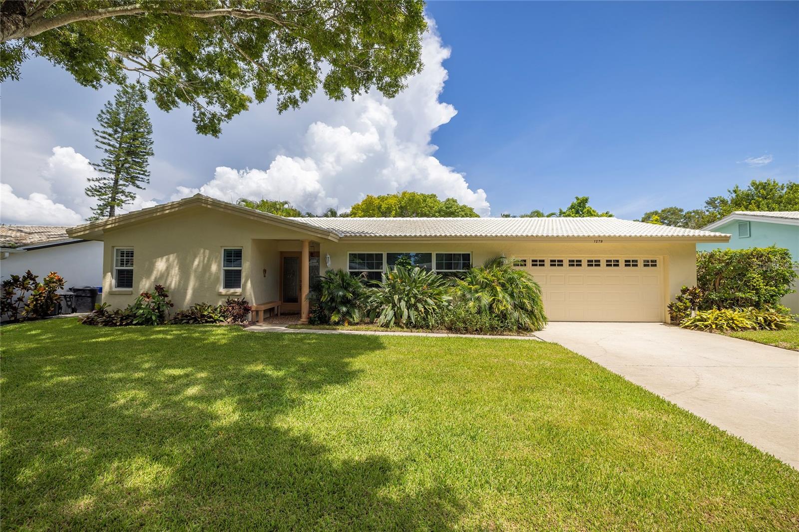 This elegant 3-bedroom, 2-bath, pool home is located in the highly desirable Ranchwood Estates neighborhood in the delightful Dunedin golf cart area close to a recently renovated park just minutes from Downtown Dunedin, Honeymoon Island, and award-winning Gulf beaches. Enjoy Florida living with a screened enclosed POOL, private fenced yard and covered patio. This beautiful split-plan home boasts wood floors and exquisite granite countertops. The huge backyard offers privacy, a large patio for a seamless blend of indoor/outdoor entertainment living, and is fenced for privacy and pool safety. Recent upgrades include a NEW dishwasher, newer HVAC (2022), garage doors (2022), front door (2023), and water heater (2019), freshly painted exterior & pool deck. Couple this with excellent schools and close to shops, airports, beaches, and all that fabulous downtown Dunedin has to offer, and you have the perfect Florida lifestyle home. Jump into your golf cart and venture downtown for dinner, or one of the many festivals or farmers' markets. The flexible layout allows for a livingroom, diningroom & familyroom or breakfast area off the kitchen.