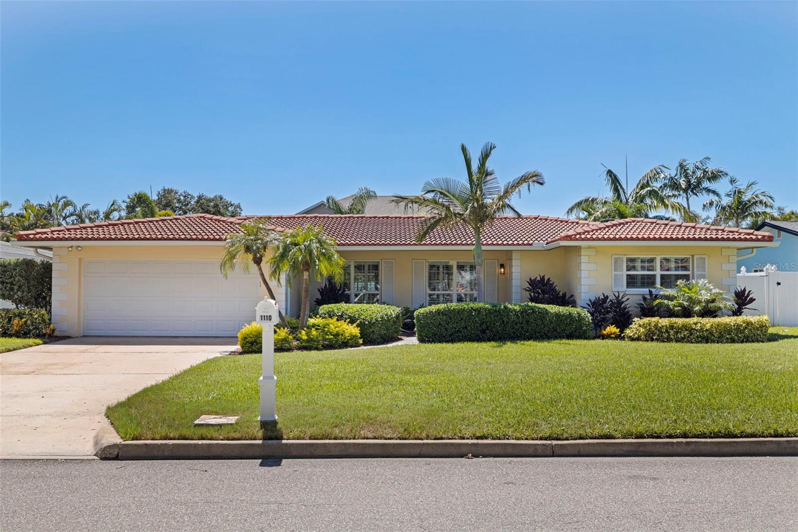 Located in the sought-after SANDS POINT NEIGHBORHOOD OF TIERRA VERDE, this ONE-STORY SOLID BLOCK POOL HOME with a fabulous backyard oasis is your ticket to paradise! This property is being offered fully furnished and turnkey, including the golf cart in the garage ... an amazing value! Surrounded by a canopy of Areca Palms and lush, tropical landscaping, the private fenced-in yard provides the perfect backdrop for endless fun and relaxation. And with a base elevation of 9-ft, this beautiful move-in ready home experienced no water intrusion or damage from previous storms ... and comes with a fully transferable Flood Policy. Take a dip in the newer (2020) oversized saltwater heated pool and adjoining spa with a large sun shelf for lounging, and be awed by the gorgeous dual waterfall feature with flaming firepits for nighttime drama! There is plenty of room for entertaining family and friends on the expansive pool deck (57x30’) with beautiful neutral beige speckled travertine tile, and the addition of newer pet-grade artificial turf makes lawn maintenance a breeze.
Inside you’ll find a chic, coastal vibe and a spacious open concept throughout the home, plantation shutters, French Door accents and wood-look tile everywhere, even in the bedrooms. As you enter this immaculately maintained home, a formal dining room greets you with beautiful coastal décor, tropical tones and a modern farmhouse chandelier. Pass through the dining room into the massive Great Room, with a dedicated bar and seating at one end, lots of natural light, and sliders that open up to the lanai and backyard oasis.
The newly updated beachy kitchen features pearl white solid wood cabinets with modern gun-metal grey hardware, high-end stainless-steel appliances, a built-in desk system, under cabinet lighting and an abundance of storage space. There is plenty of extra room to add a breakfast table or bistro table for casual dining, and bar stools provide bonus seating along the countertop facing into the kitchen and adjacent to the Great Room. The kitchen leads out to a generous laundry and utility room, connecting with a 2-car garage.
The casually elegant primary bedroom features an ensuite bath, walk-in closet, an updated shower with herringbone pattered tile and a rain shower head. An inviting secondary bedroom has a dedicated hall bath, and is also newly updated with a rain head shower and tub. The third bedroom with sliding modern barn doors serves as a guest room with pullout bed, or can double as a home office. Other recent upgrades include a water filtration system, new pool pump, new AC duct work, gutter system and new exterior doors.
TIERRA VERDE IS A SPECTACULAR ISLAND PARADISE tucked quietly away with easy access to everywhere! Head west within minutes to Gulf coast beaches, and it’s just a short drive to downtown St. Pete with its cultural attractions, entertainment, and fabulous restaurants. Fort DeSoto – an 1100 acre park offering an array of beaches, fishing, camping, kayaking and miles of nature trails – is right down the Bayway! Plus, it’s only 30-40 minutes via I-275 to both international airports: TPA and SRQ. Schedule your showing today for an opportunity to own this beautiful piece of paradise!