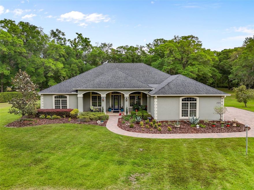 Welcome to Wyndsong Manor, an exclusive private gated community.  Designed and built in 2014 by Henley & Evans, this exceptional luxury home offers a perfect blend of elegant living and modern energy efficiency. The home features 4 bedrooms, 3 full baths, plus a study with glass French doors and a closet — ideal for a home office or a 5th bedroom. The three-way contemporary open floor plan provides an exceptional flow, highlighted by 12- to 14-foot ceilings, crown molding, 5¼” base trim, and transom windows throughout.
The Great Room is the centerpiece of the home, offering a cozy gas fireplace and three sets of French doors leading to the screened lanai and resort-style pool. Entertain in style in the formal dining room, or enjoy casual meals in the spacious breakfast area with custom built-ins.
The gourmet kitchen is a chef’s dream, featuring custom cabinetry with pull-out shelves, dual spice racks, a tile/glass backsplash, a cooktop with double ovens, a wall-mounted microwave, and a new refrigerator. A Butler’s pantry and dry bar area add even more storage and function.
The luxurious Owner’s Suite features dual walk-in closets with custom Top Shelf storage and transom windows. The spa-like master bath offers a jetted tub, a large glassed walk-in shower with multiple showerheads, dual granite vanities, and a private water closet.
Additional features include an oversized 3-car side-entry garage with an epoxy-coated floor, an inside laundry room with washer, dryer, ironing board, and utility sink, and a mechanical room housing dual HVAC systems, dual water heaters, and storage space.
Outdoor living is exceptional, with sealed paver driveways and walkways, a screened saltwater pool with beach entry, sitting shelves, a heated spa, and a cabana featuring a summer kitchen with a commercial grill and professional ventilation.
This home is powered by a whole-home owned solar system, includes a water softener and filtration system, and offers an owned security system with cameras and glass sensors. A built-in sound system services both the Great Room and outdoor lanai.
Experience the perfect balance of privacy, luxury, and modern living — all just moments from Gainesville’s best conveniences.