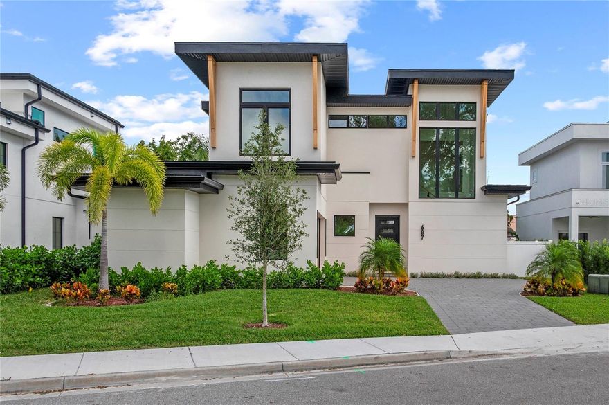 Discover sophisticated modern living at 607 Ellen Drive, a stunning new construction home by the acclaimed Lazarus Homes in the heart of Winter Park. This impeccably designed 2,812-square-foot residence showcases contemporary architecture with clean lines, high ceilings, and an abundance of natural light throughout. The open floor plan seamlessly connects living spaces, creating an ideal setting for both everyday life and elegant entertaining.
The chef's kitchen is a true showpiece, featuring top-of-the-line Monogram appliances, a sleek Ruvati sink, built-in oven and microwave, and a professional gas range. Gorgeous Taj Mahal Quartzite countertops provide both beauty and durability, while thoughtful design elements include the option for a full-height wine refrigerator or additional cabinetry to suit your lifestyle. The living room offers a modern ambiance with an electric fireplace and expansive glass sliders that open to a covered lanai overlooking your private pool—perfect for Florida's indoor-outdoor lifestyle. For those who love to entertain, the home has been pre-stubbed for an optional outdoor kitchen.
The luxurious first-floor primary suite provides a private retreat with a spa-inspired en suite bath featuring a double sink vanity, walk-in shower, soaking tub, and an oversized walk-in closet complete with custom built-ins and convenient washer and dryer hookups. Upstairs, the home continues to impress with a generous bonus room, a sophisticated loft with glass walls, three additional bedrooms, two full baths, and a second laundry area for ultimate convenience. A dedicated pool bath adds another layer of functionality for poolside enjoyment.
Nestled in the desirable Lake Killarney Shores community, this home offers the perfect blend of tranquility and accessibility. Residents enjoy a low HOA, private boat launch access to Lake Killarney, and the convenience of being within walking distance to Winter Park's renowned restaurants, boutiques, and cultural attractions. This is move-in ready modern luxury at its finest.